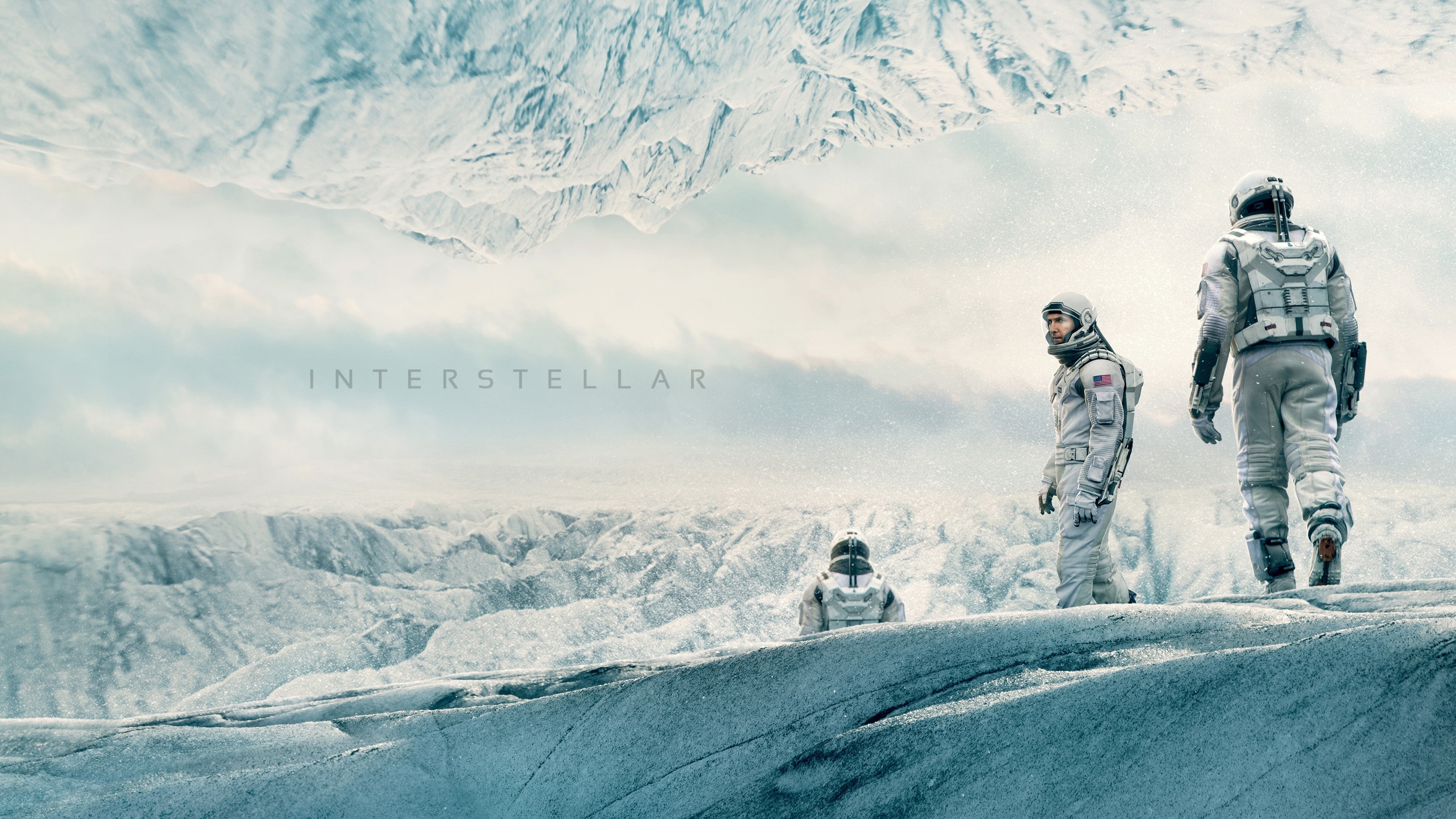 Interstellar movie poster with astronauts on icy planet HD Wallpaper