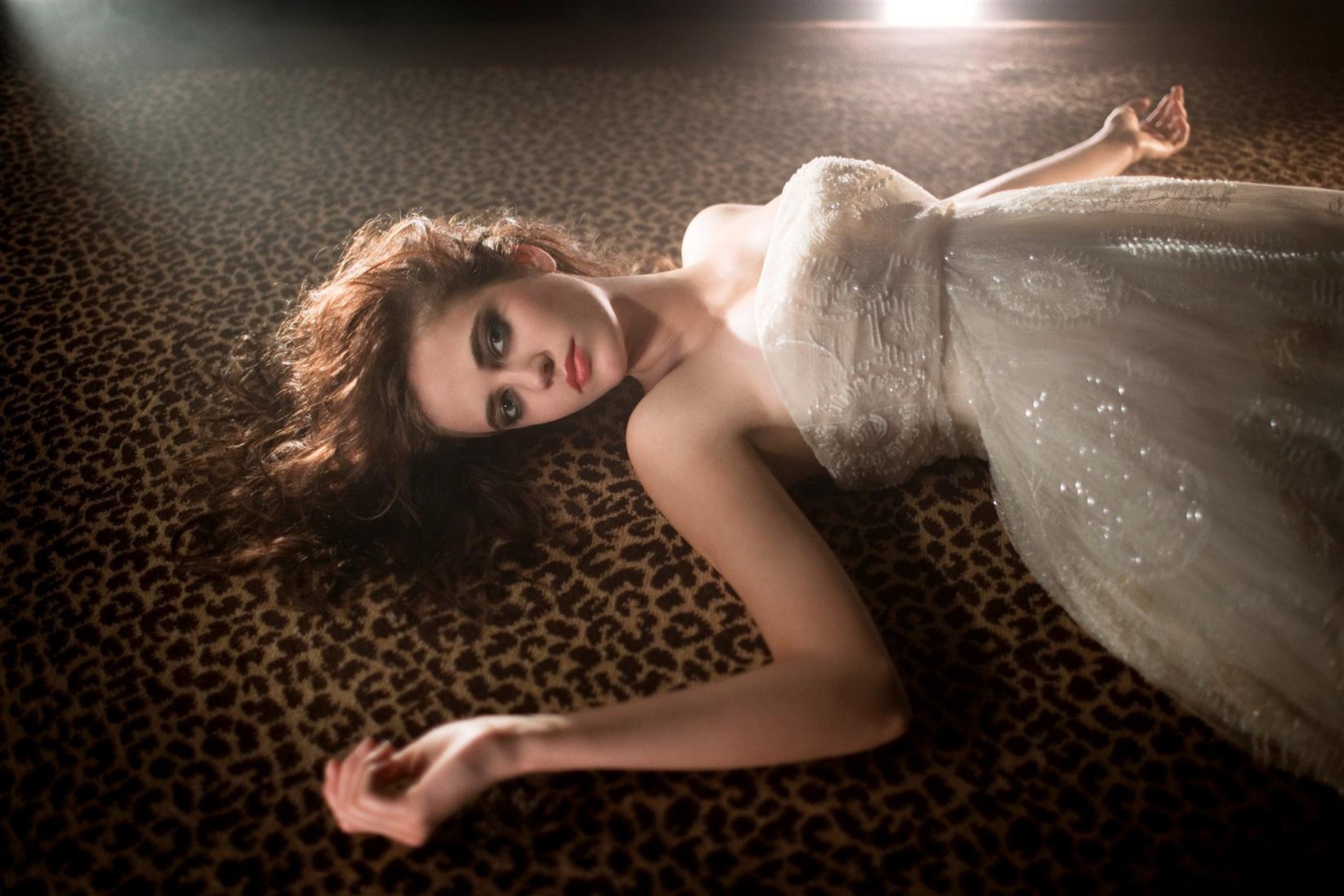 Woman in white dress lying on animal print carpet HD Wallpaper