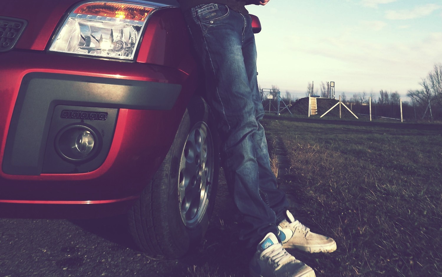 Person leaning on a red Ford Fusion car HD Wallpaper