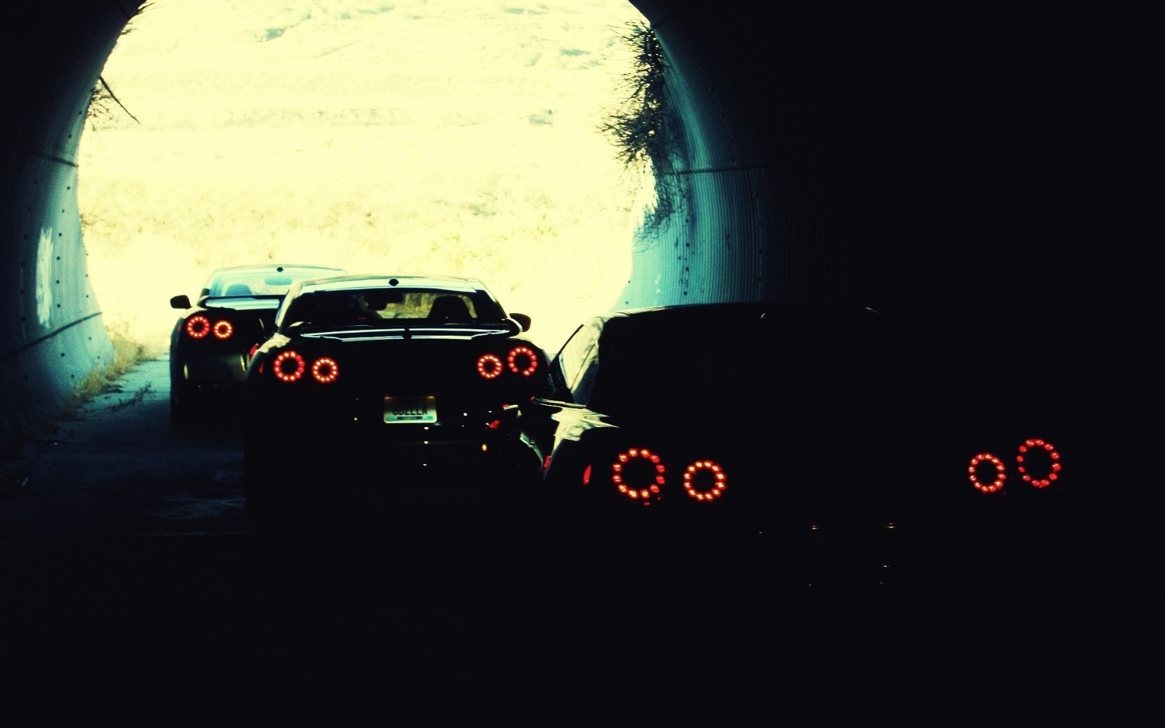 Three Nissan GT-R cars in a tunnel at night HD Wallpaper