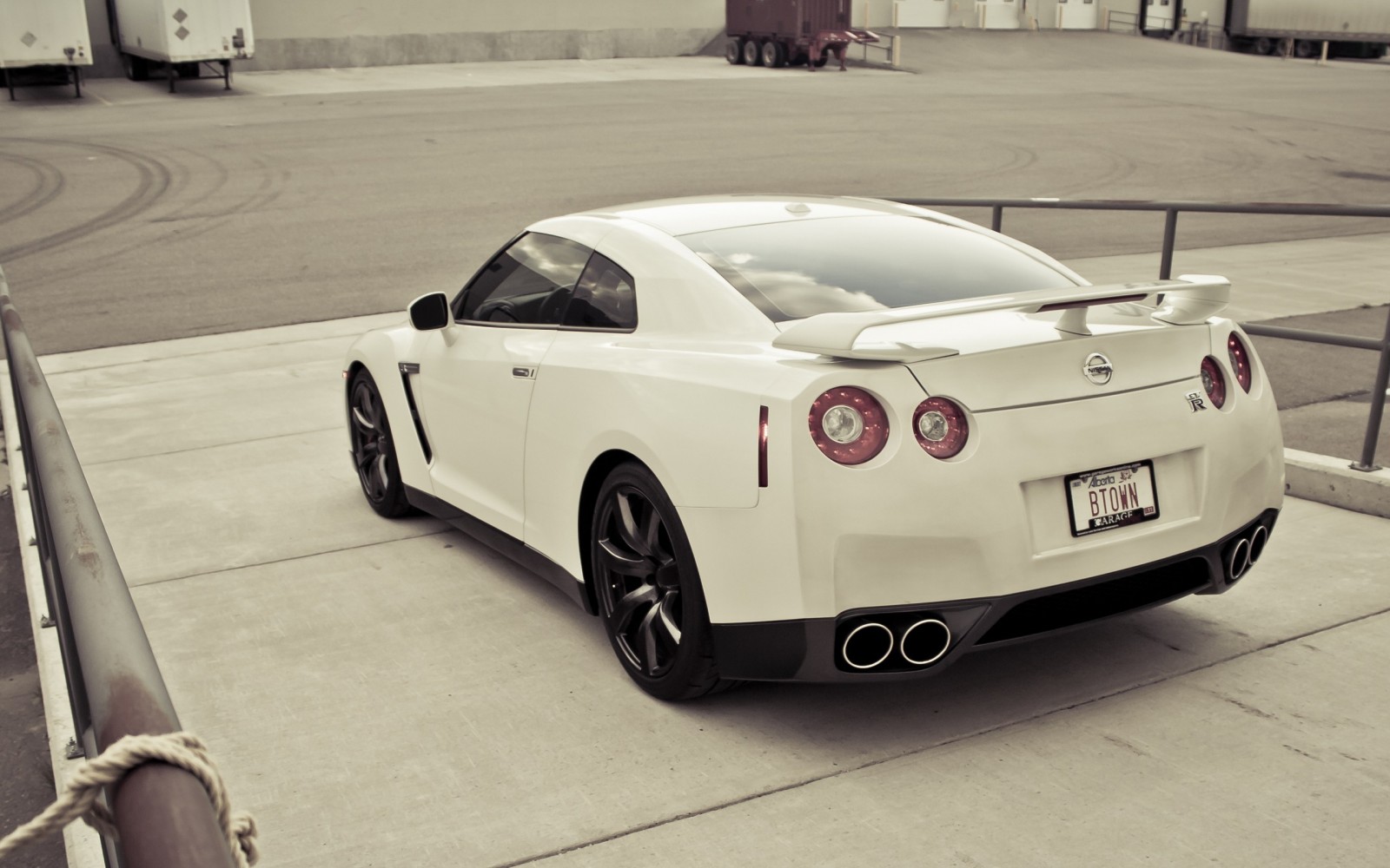 White Nissan GT-R parked on concrete HD Wallpaper