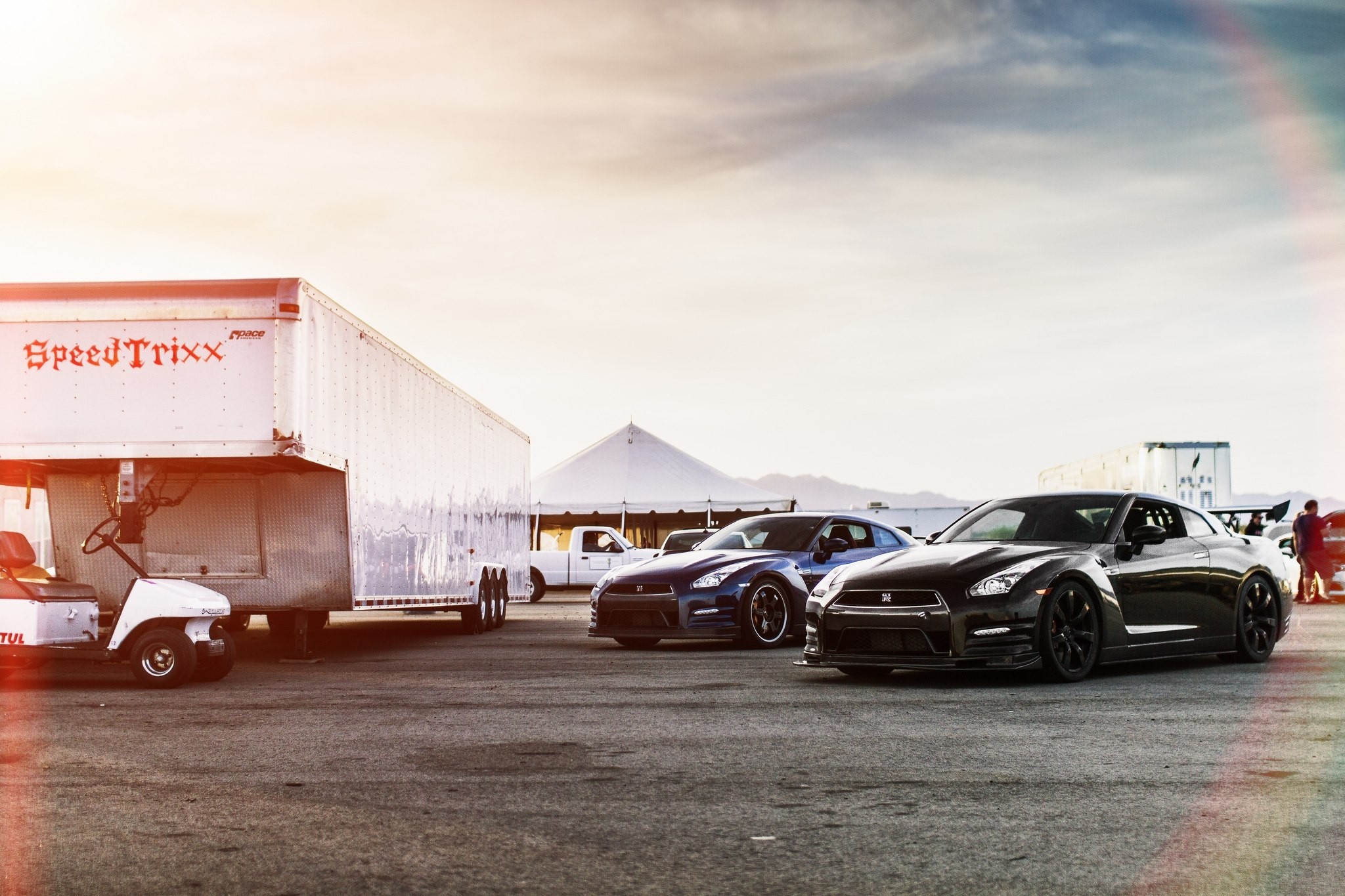 Nissan GT-R cars and trailer at a sport venue HD Wallpaper