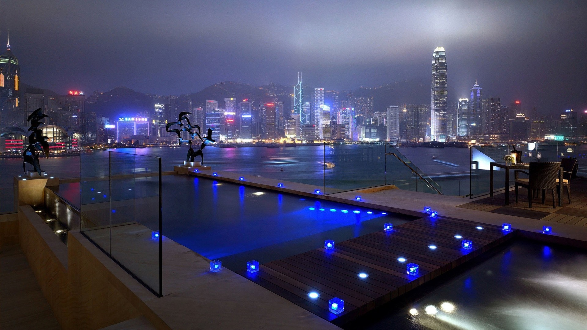 Night cityscape of Hong Kong with a swimming pool and sculptures HD Wallpaper
