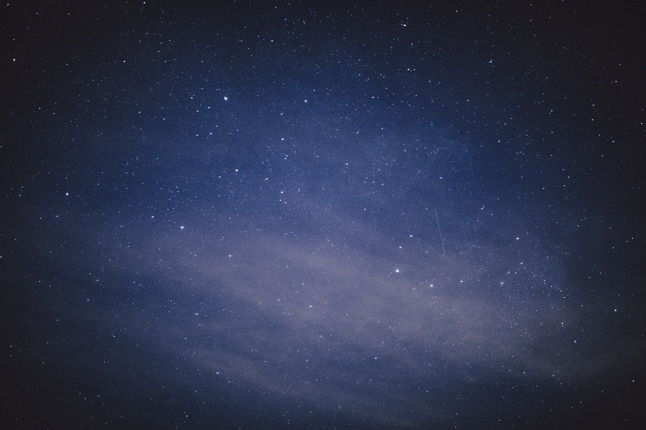 Starry night sky with a faint nebula HD Wallpaper
