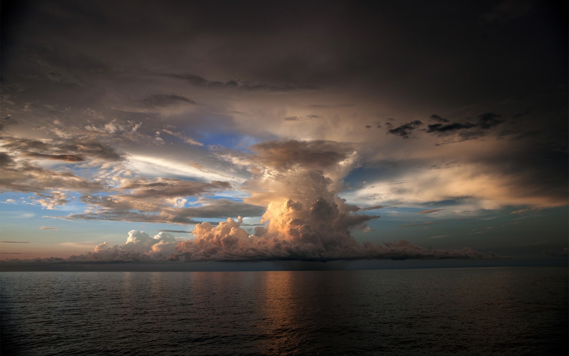 Dramatic storm clouds over the ocean at sunset HD Wallpaper