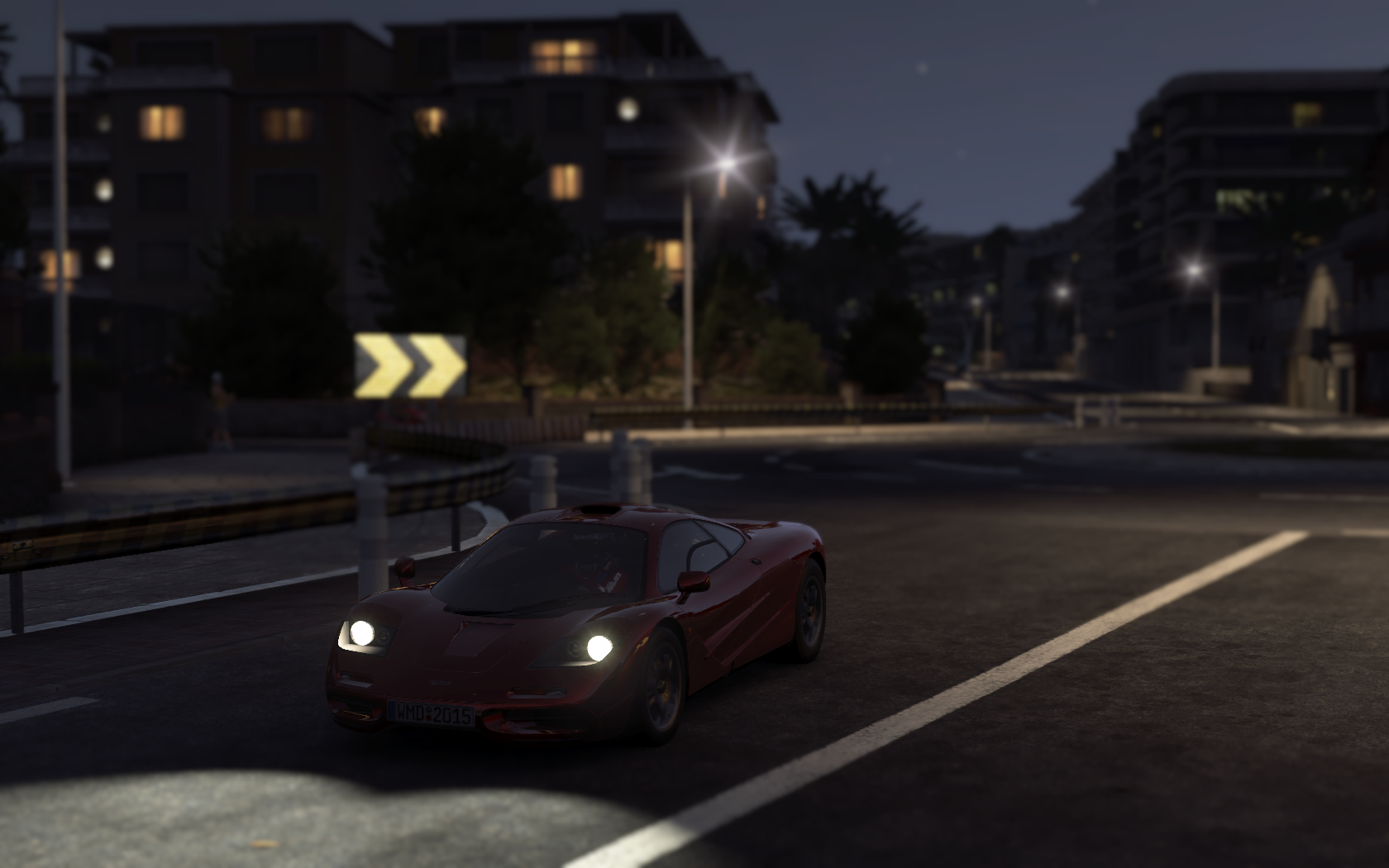 Red McLaren F1 driving on a street at night HD Wallpaper