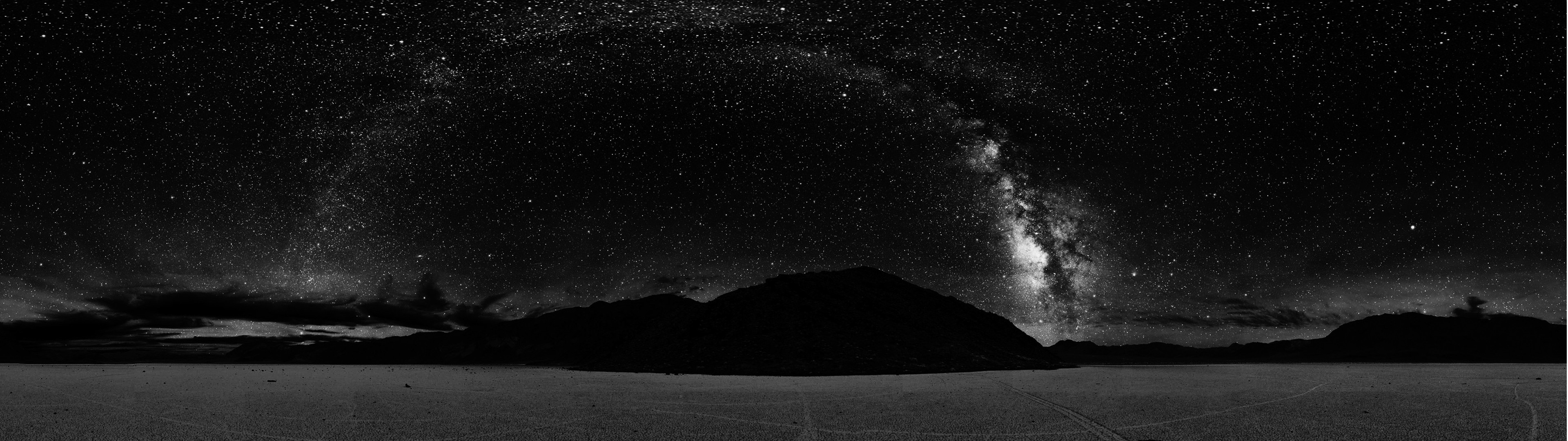 Panoramic view of the Milky Way over mountains and a plain HD Wallpaper