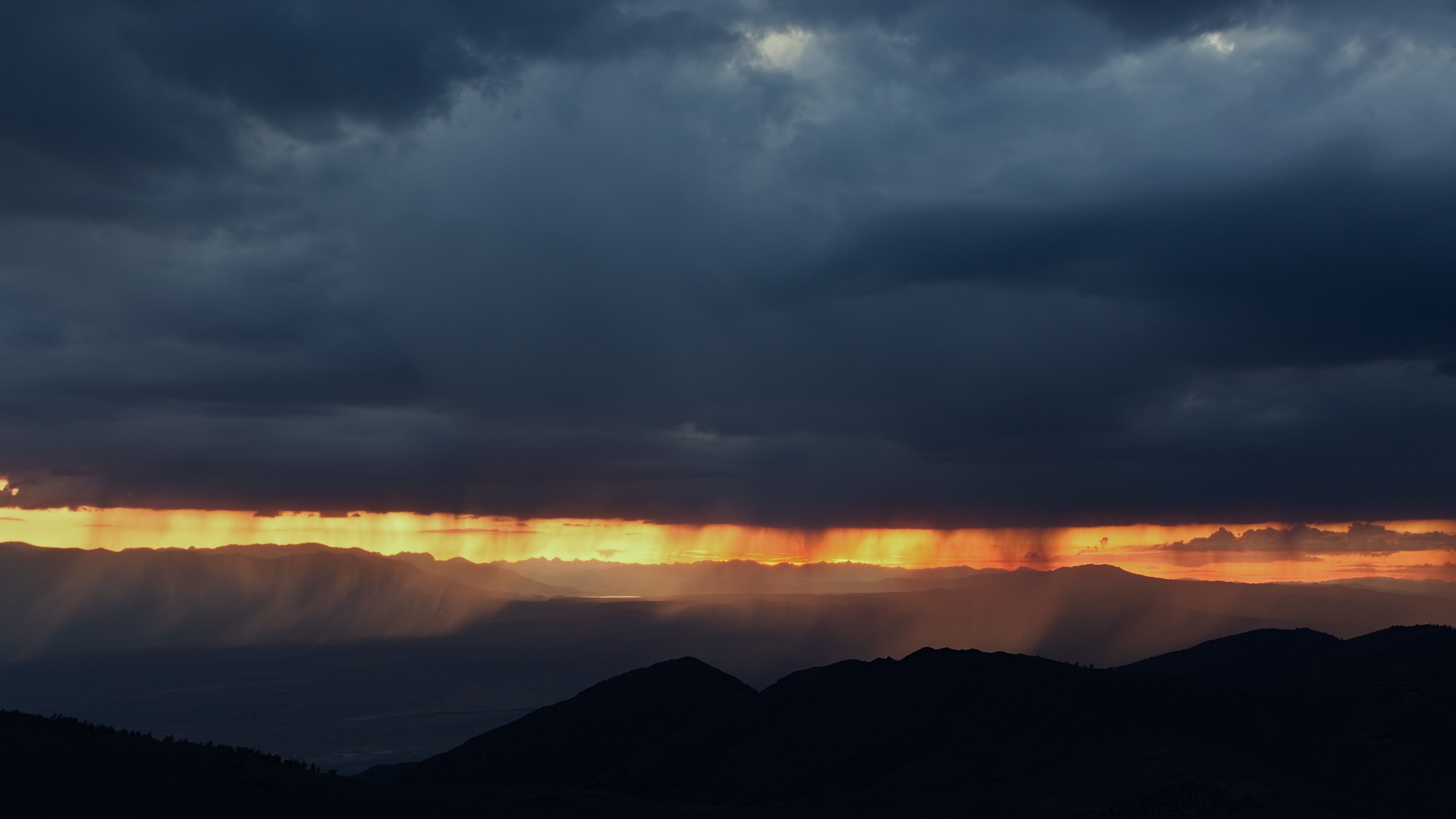 Sunset rain over mountains with dark clouds HD Wallpaper
