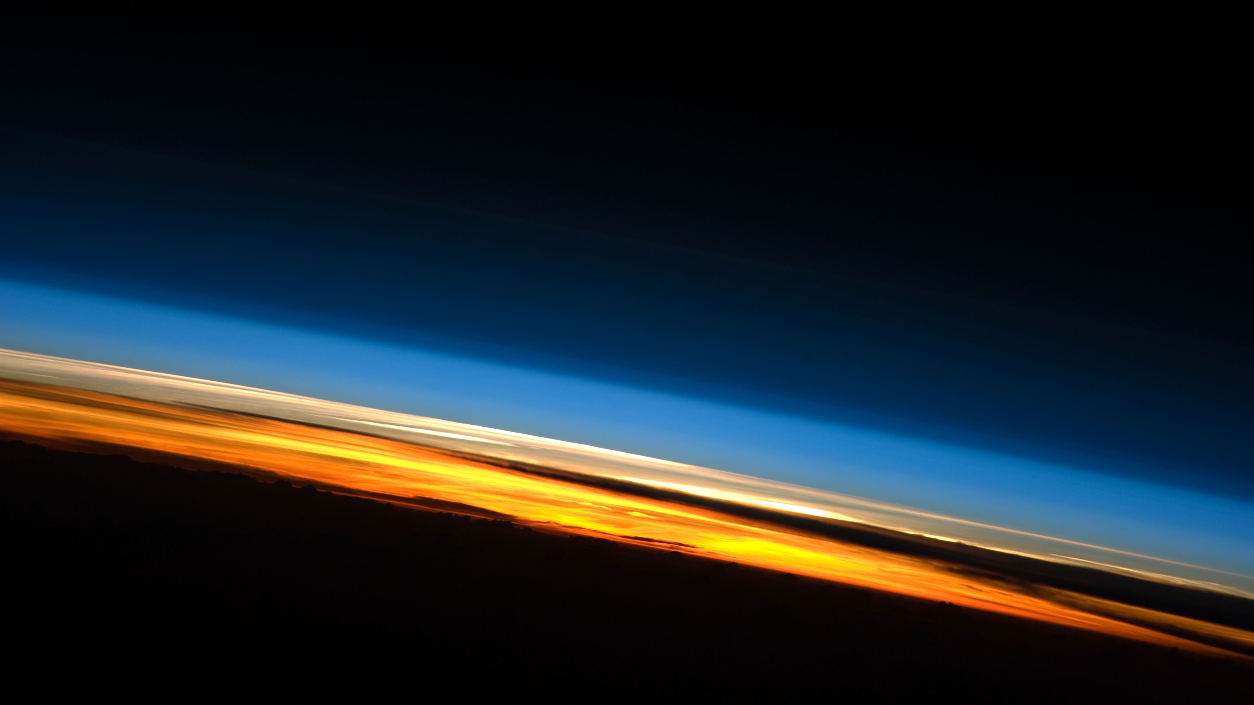 Atmospheric layer at sunset viewed from space HD Wallpaper
