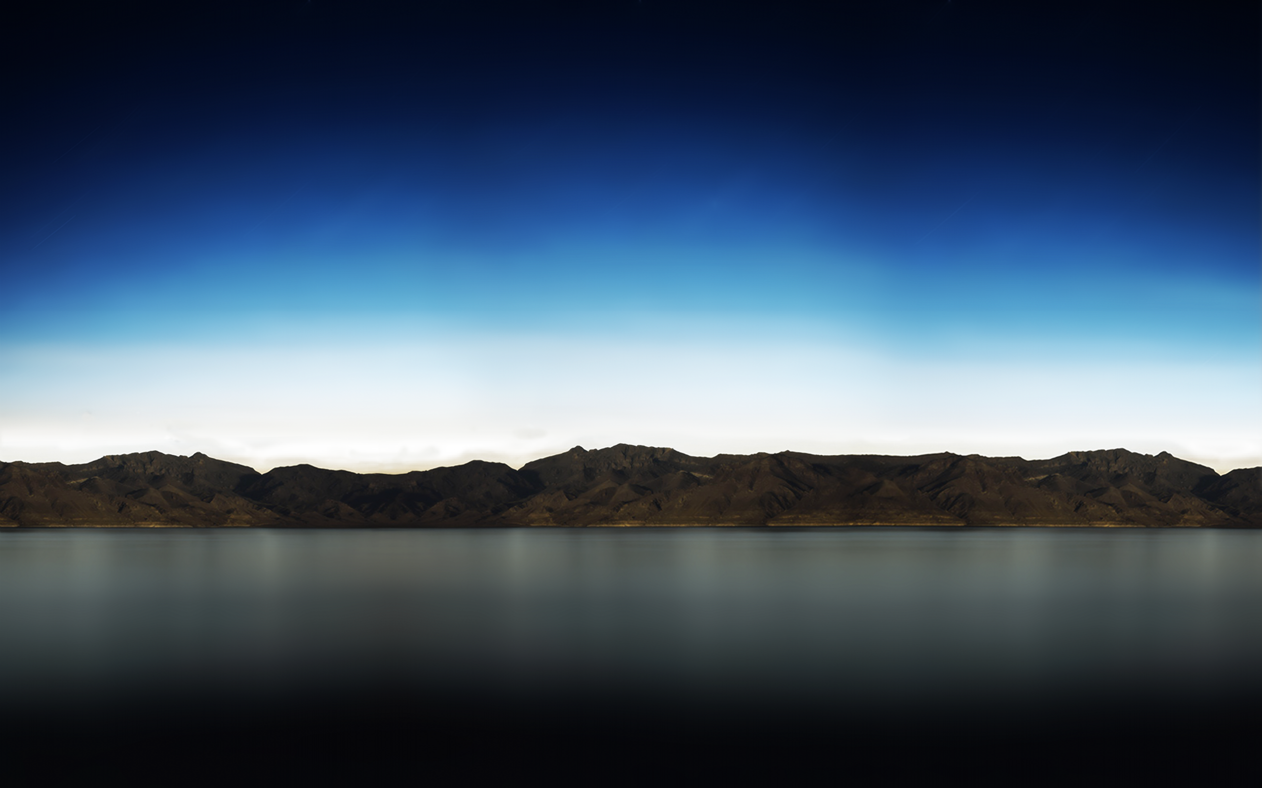 Mountain range reflected in a dark lake under a gradient sky HD Wallpaper