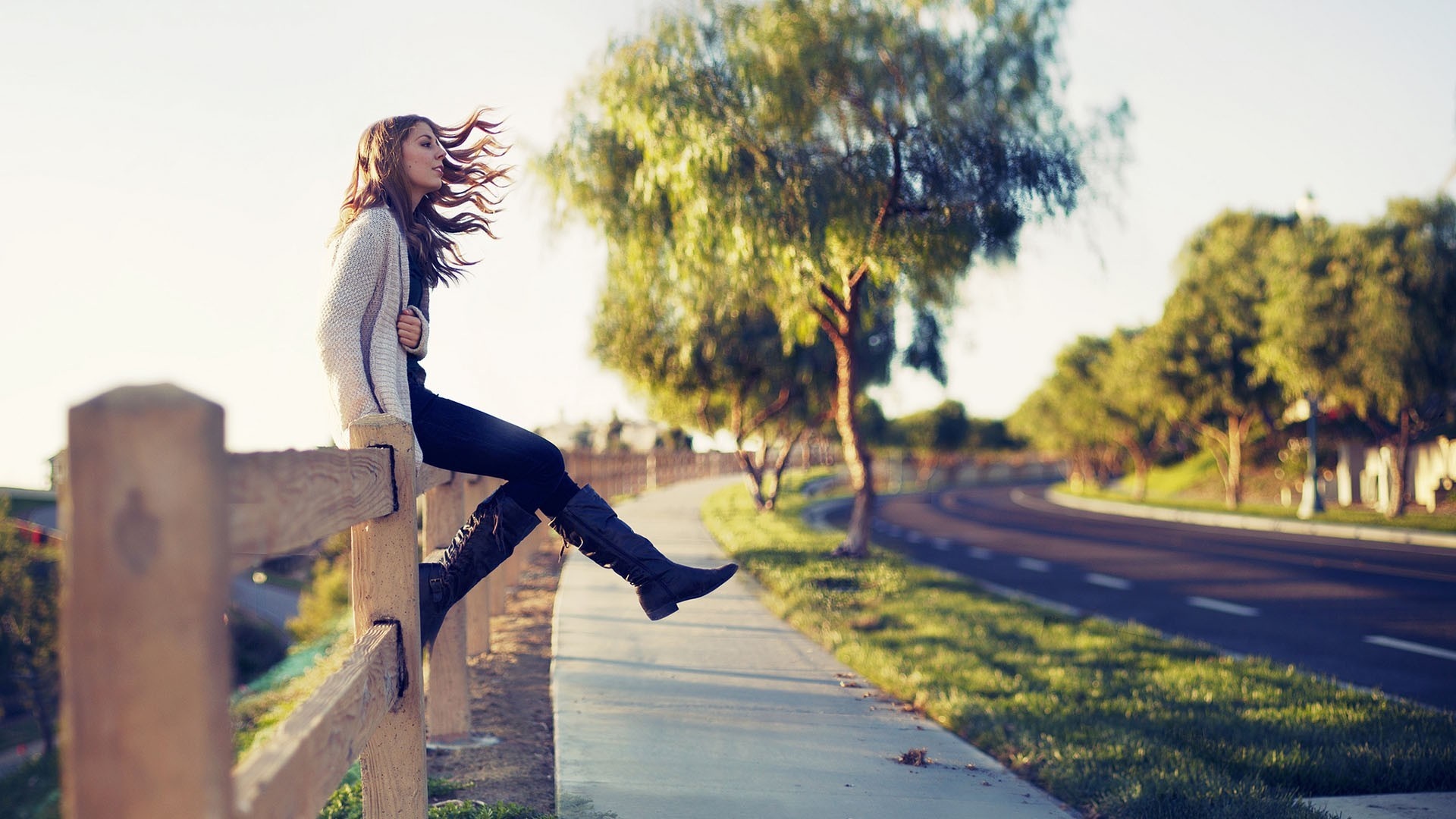 Woman sitting on a wooden fence outdoors HD Wallpaper
