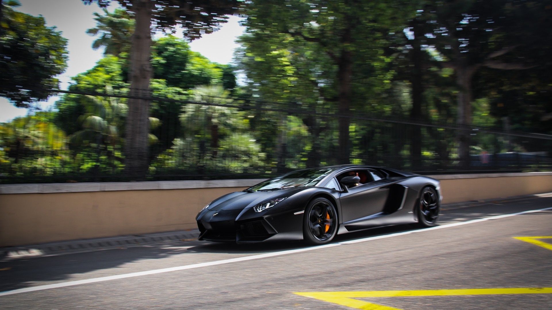 Black Lamborghini Aventador driving on a road HD Wallpaper