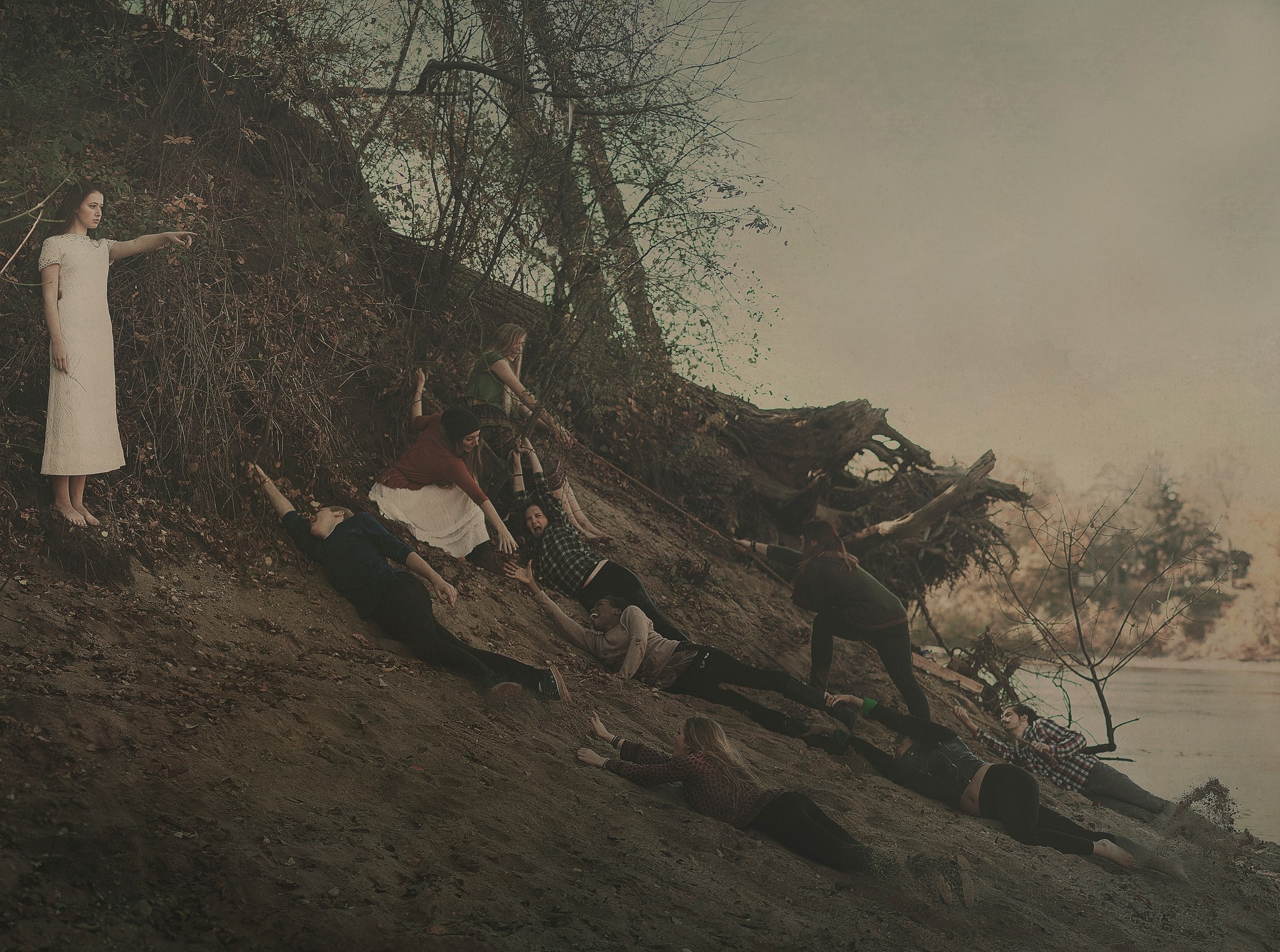 Group of people on a muddy bank by a river HD Wallpaper