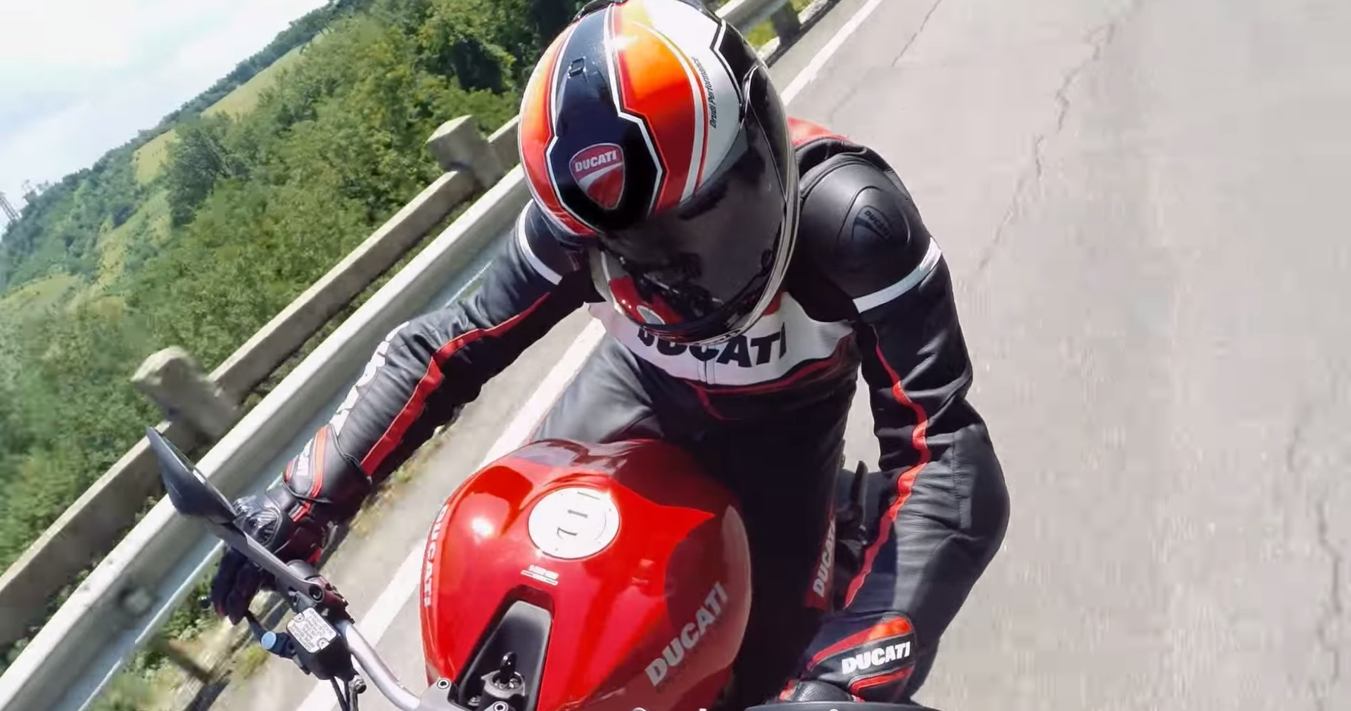 Motorcyclist in Ducati gear riding a red Ducati motorcycle HD Wallpaper
