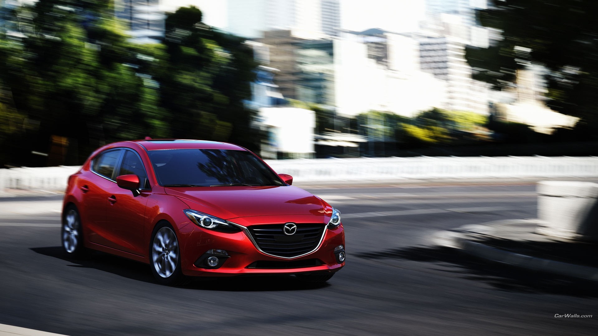 Red Mazda 3 Hatchback driving on a city street HD Wallpaper
