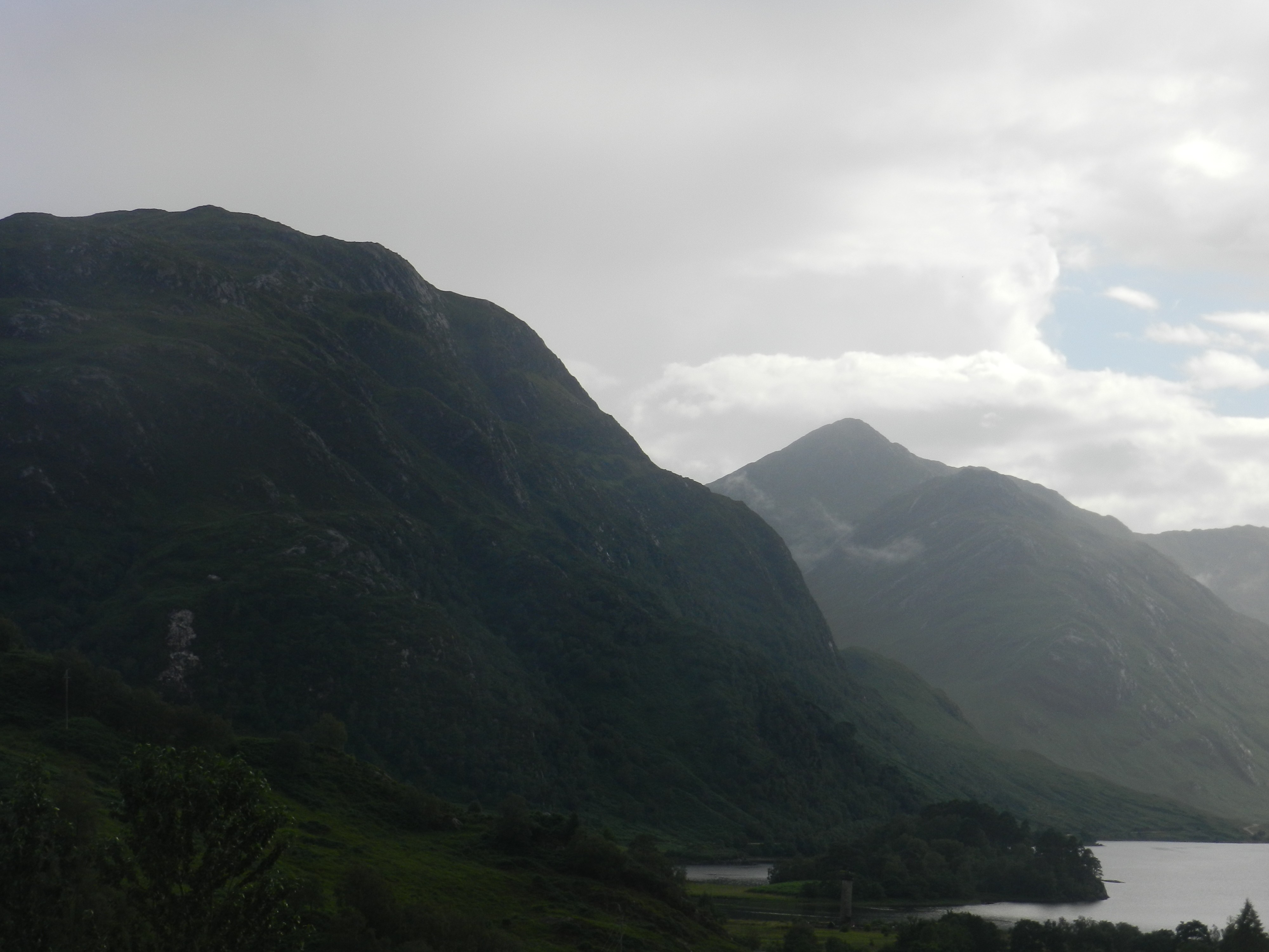 Misty mountains and a lake in a valley HD Wallpaper