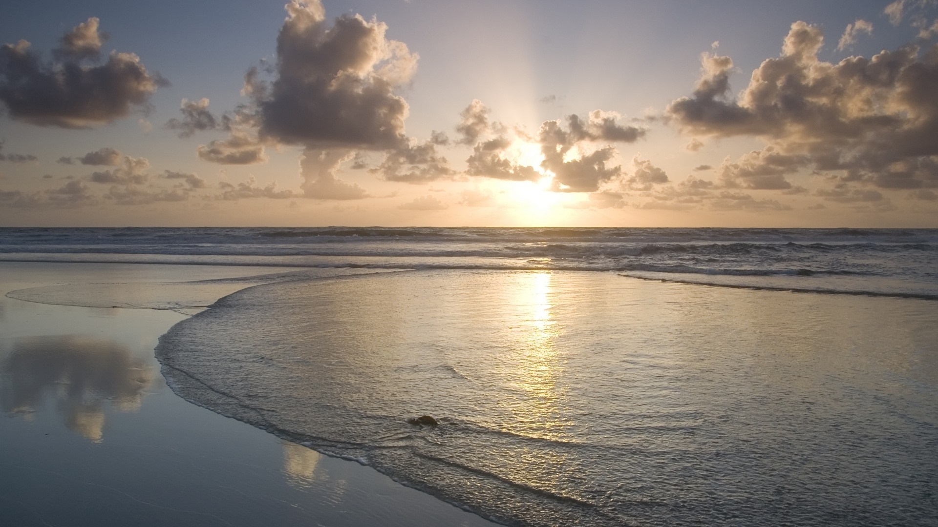 Sunset over the ocean with clouds and reflections on the shore HD Wallpaper