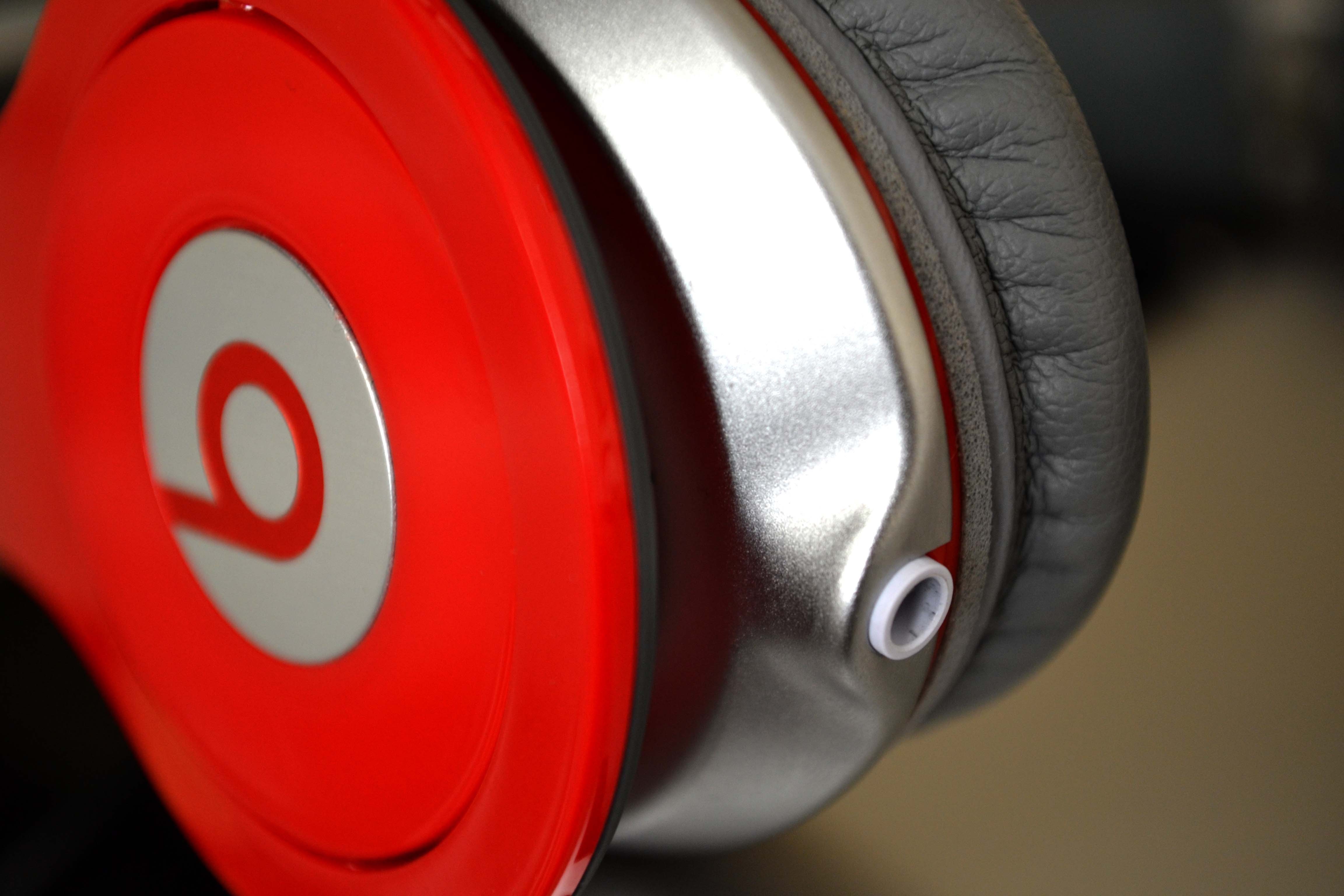 Close-up of red Beats headphones with silver accents HD Wallpaper