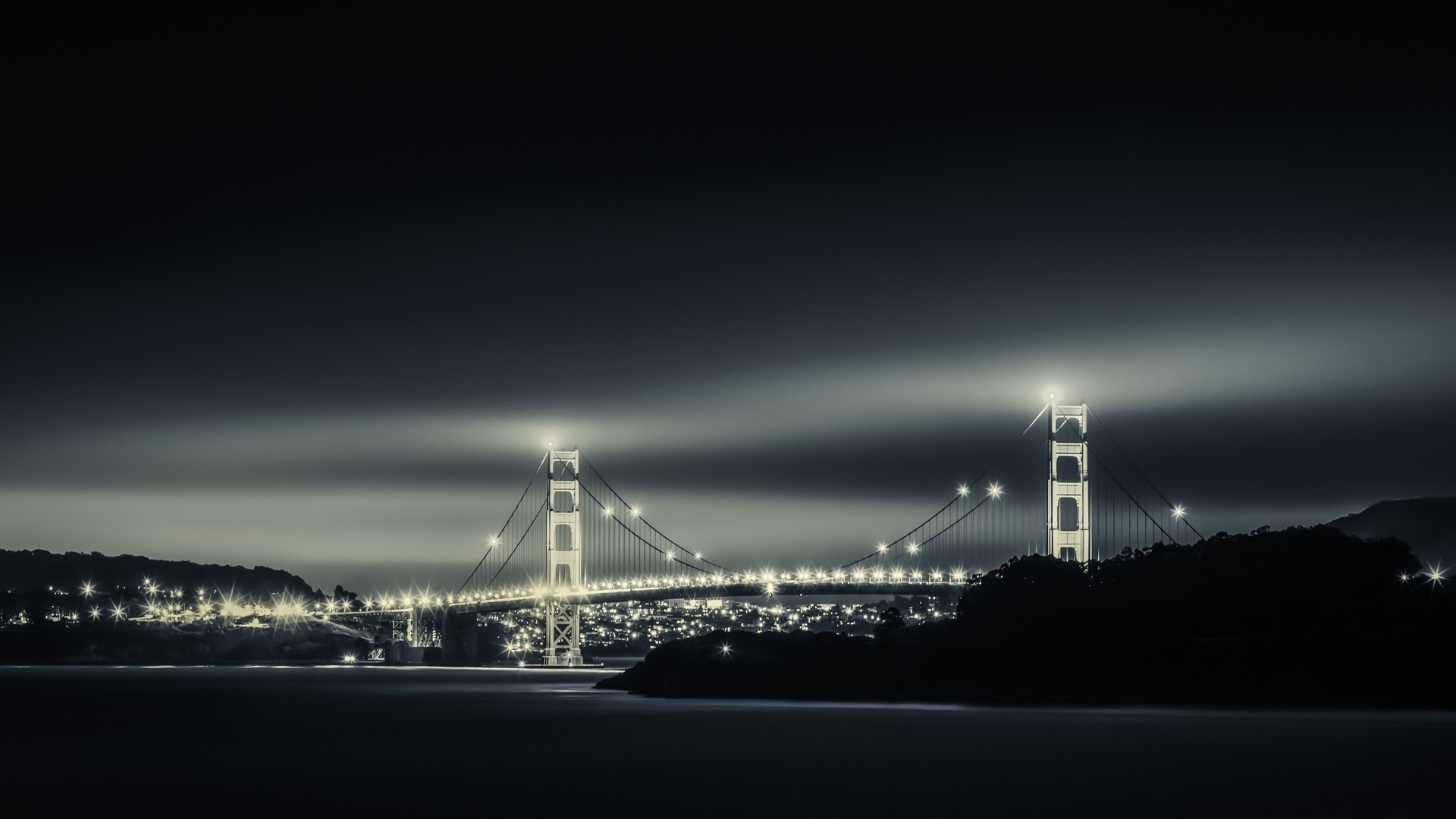 Golden Gate Bridge at night with city lights HD Wallpaper
