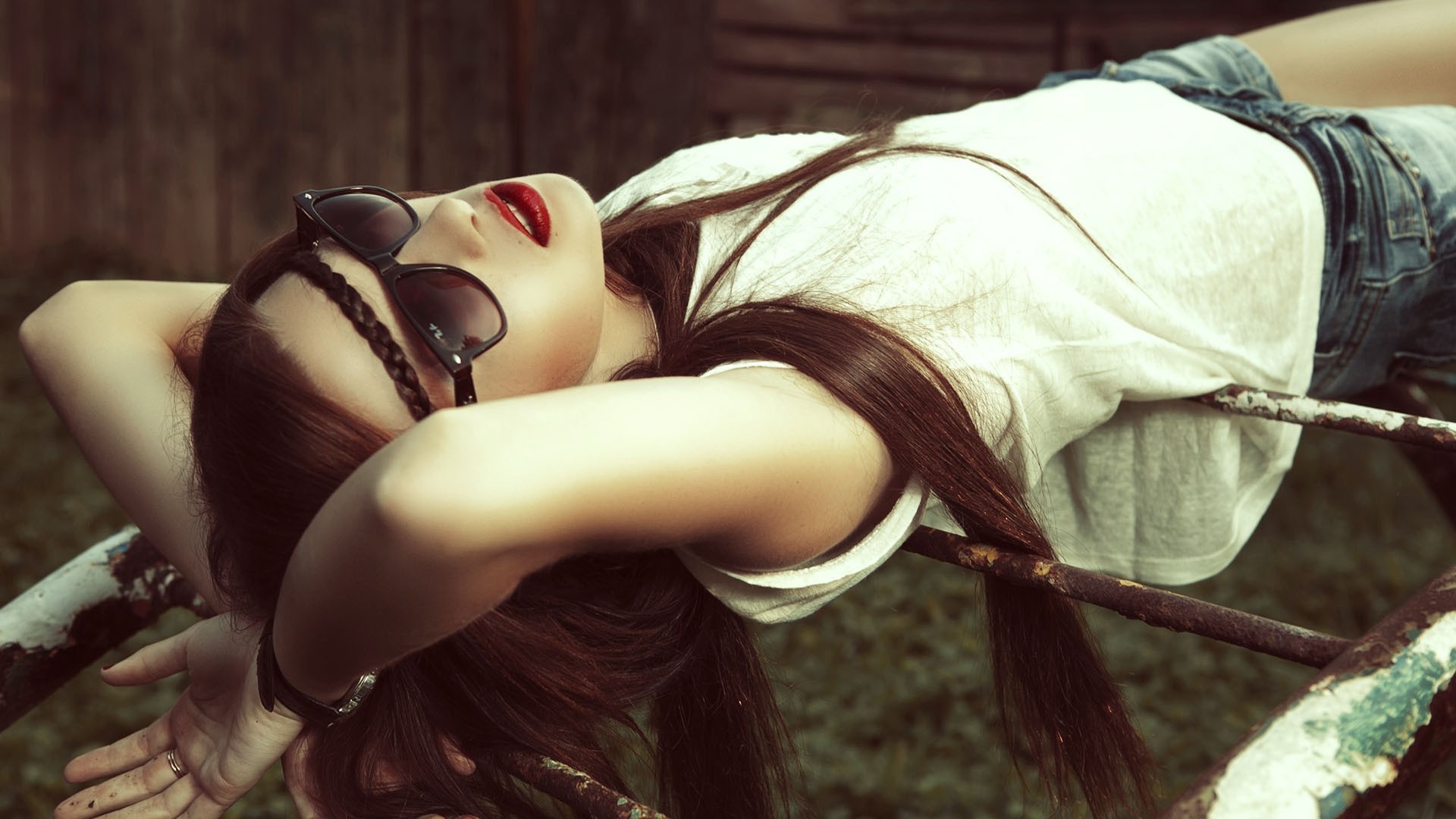 Woman with sunglasses lying on a metal bar HD Wallpaper