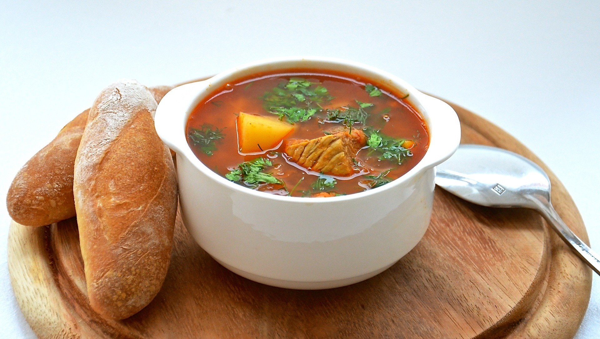 Hearty soup with bread and spoon HD Wallpaper