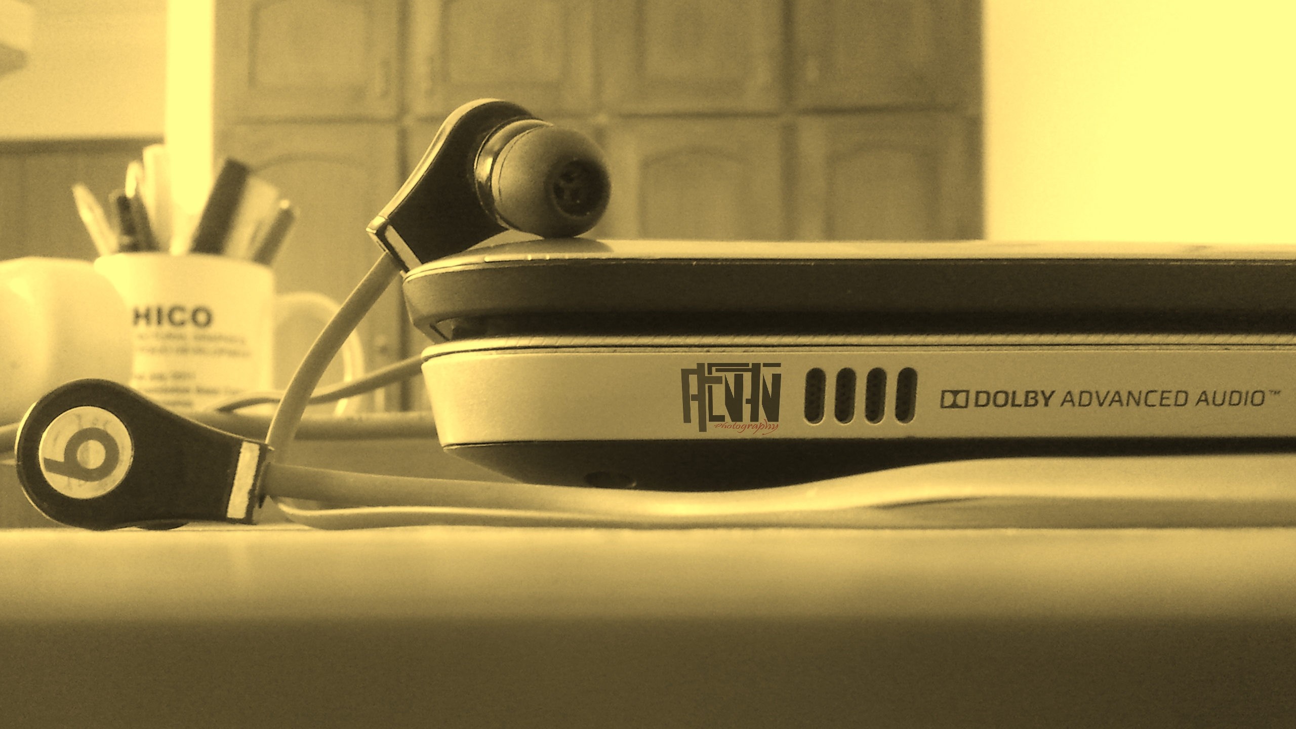 Beats headphones on a laptop with Dolby Advanced Audio HD Wallpaper