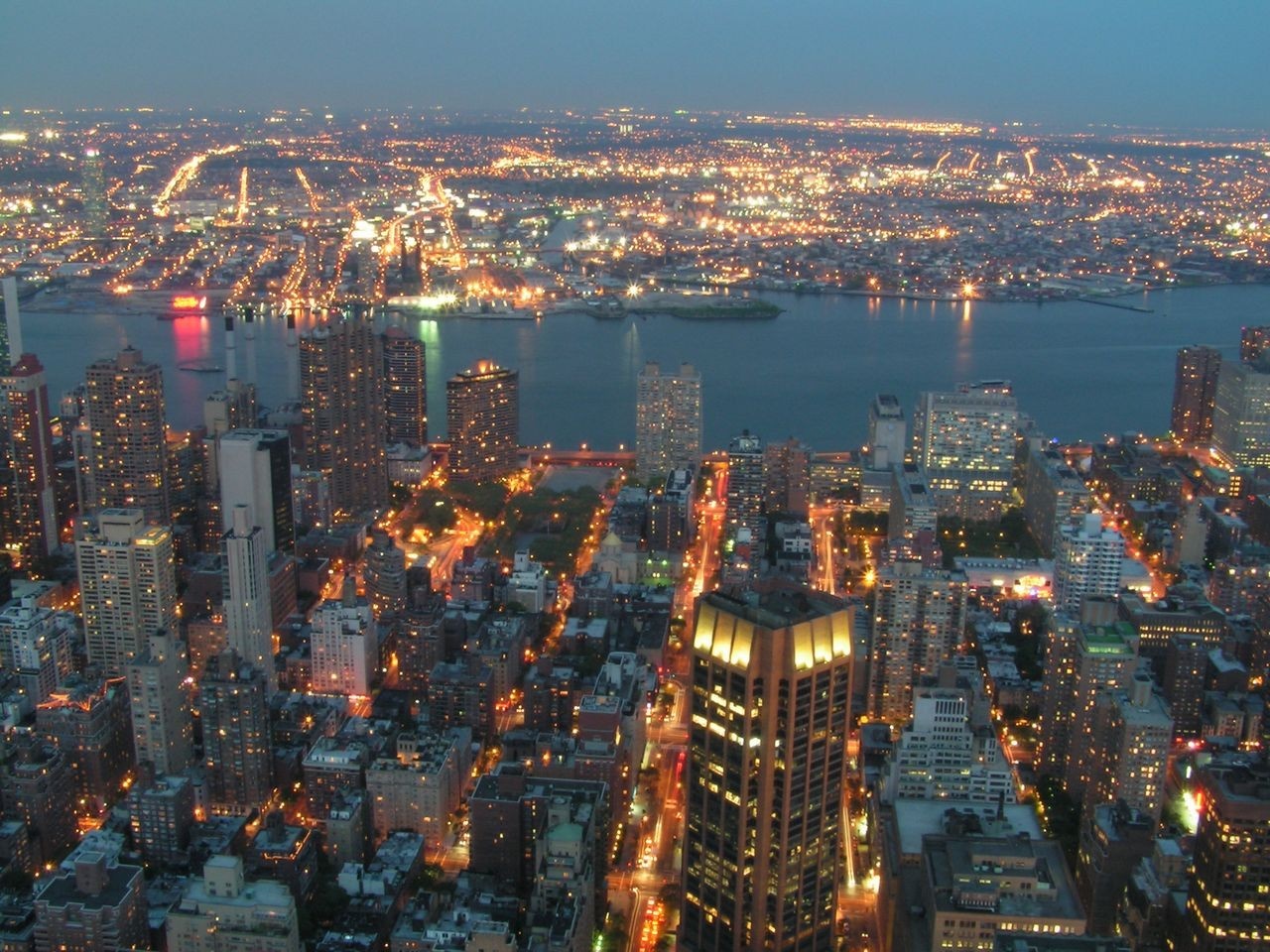 Aerial view of a city skyline at night HD Wallpaper