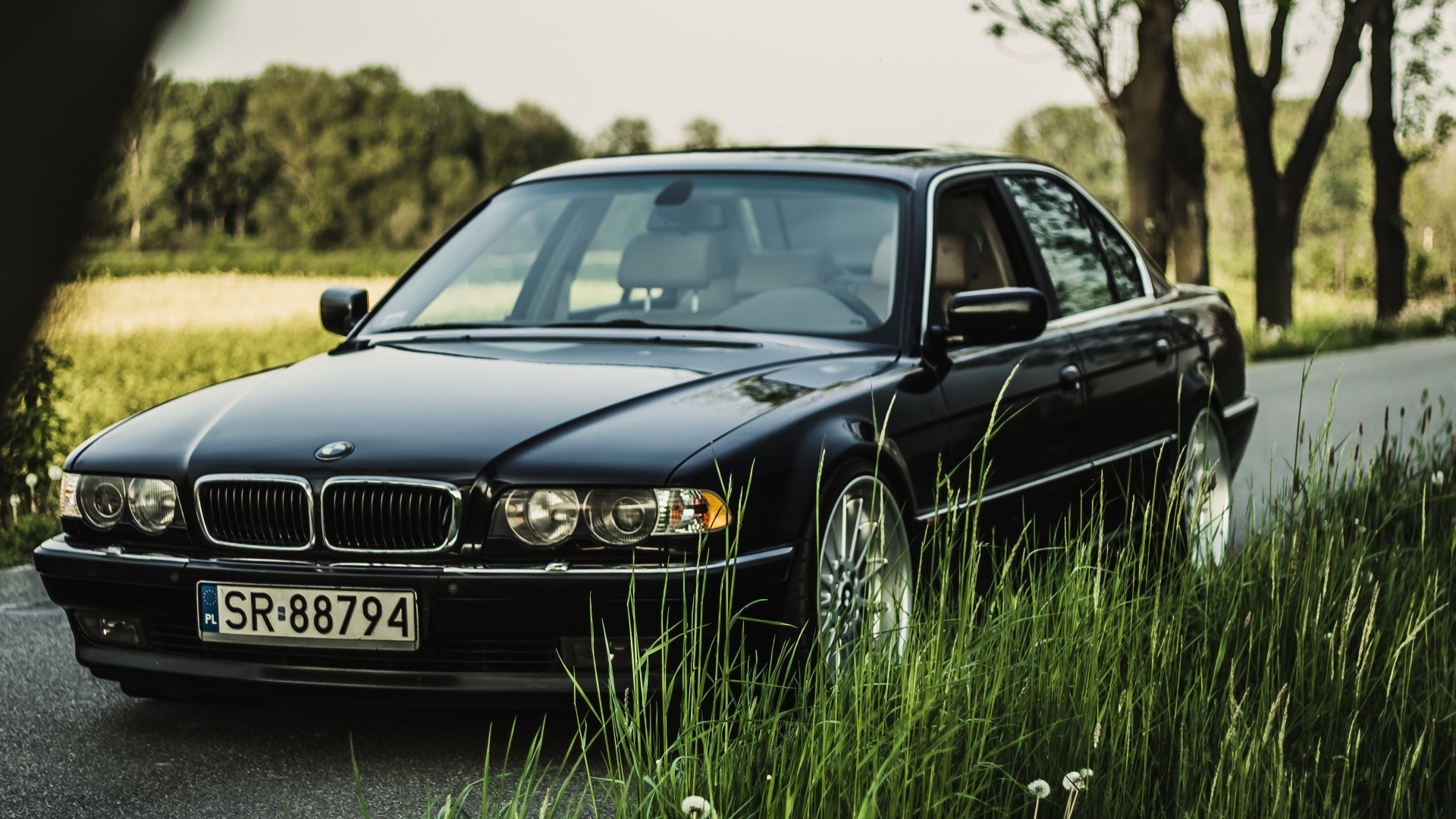 Black BMW 7 Series Sedan on a Country Road HD Wallpaper