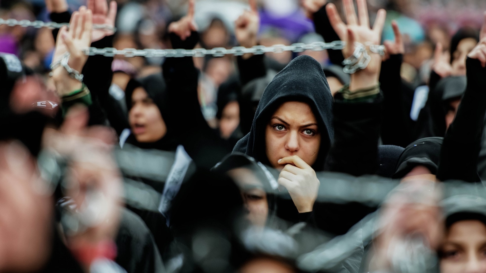 People with chains in a crowd HD Wallpaper