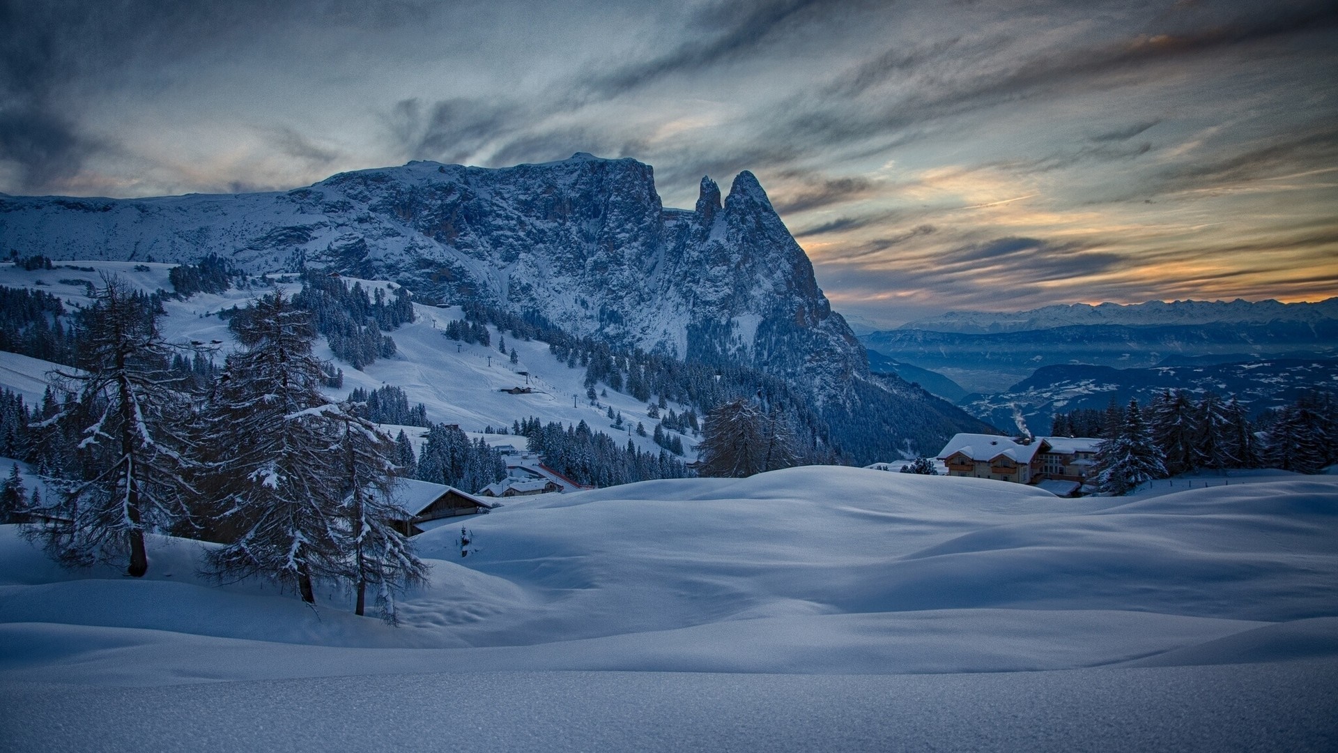 Snowy mountain landscape with chalets at sunrise HD Wallpaper