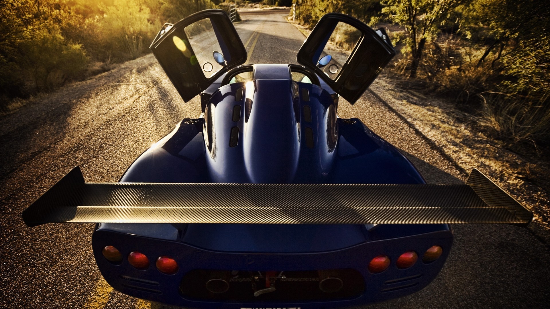 Ultima GTR sports car with doors and spoiler HD Wallpaper