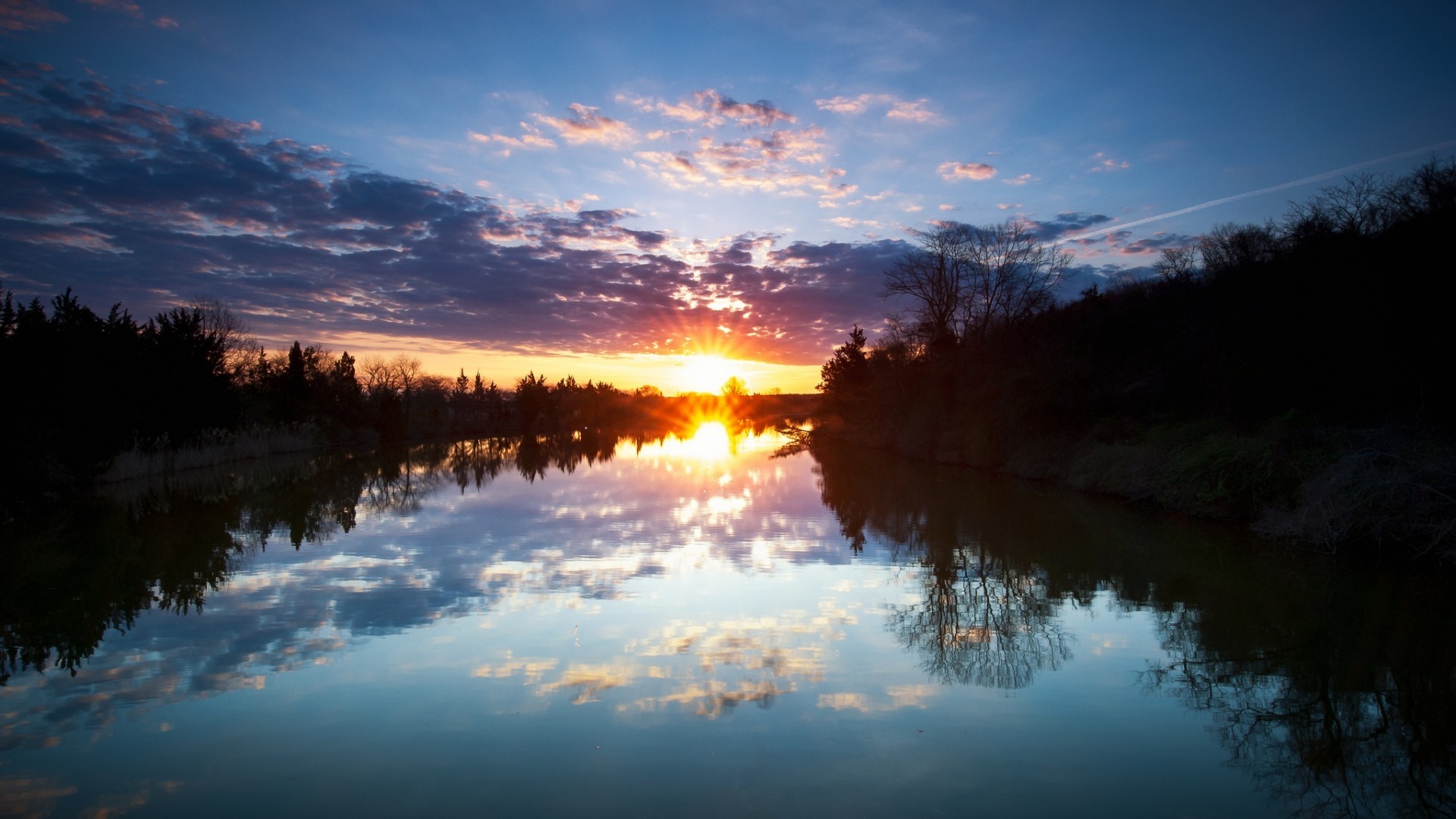 Sunset over a calm lake with reflections HD Wallpaper