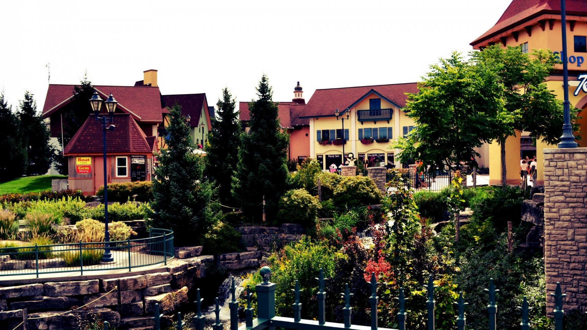 European-style village with shops and greenery HD Wallpaper