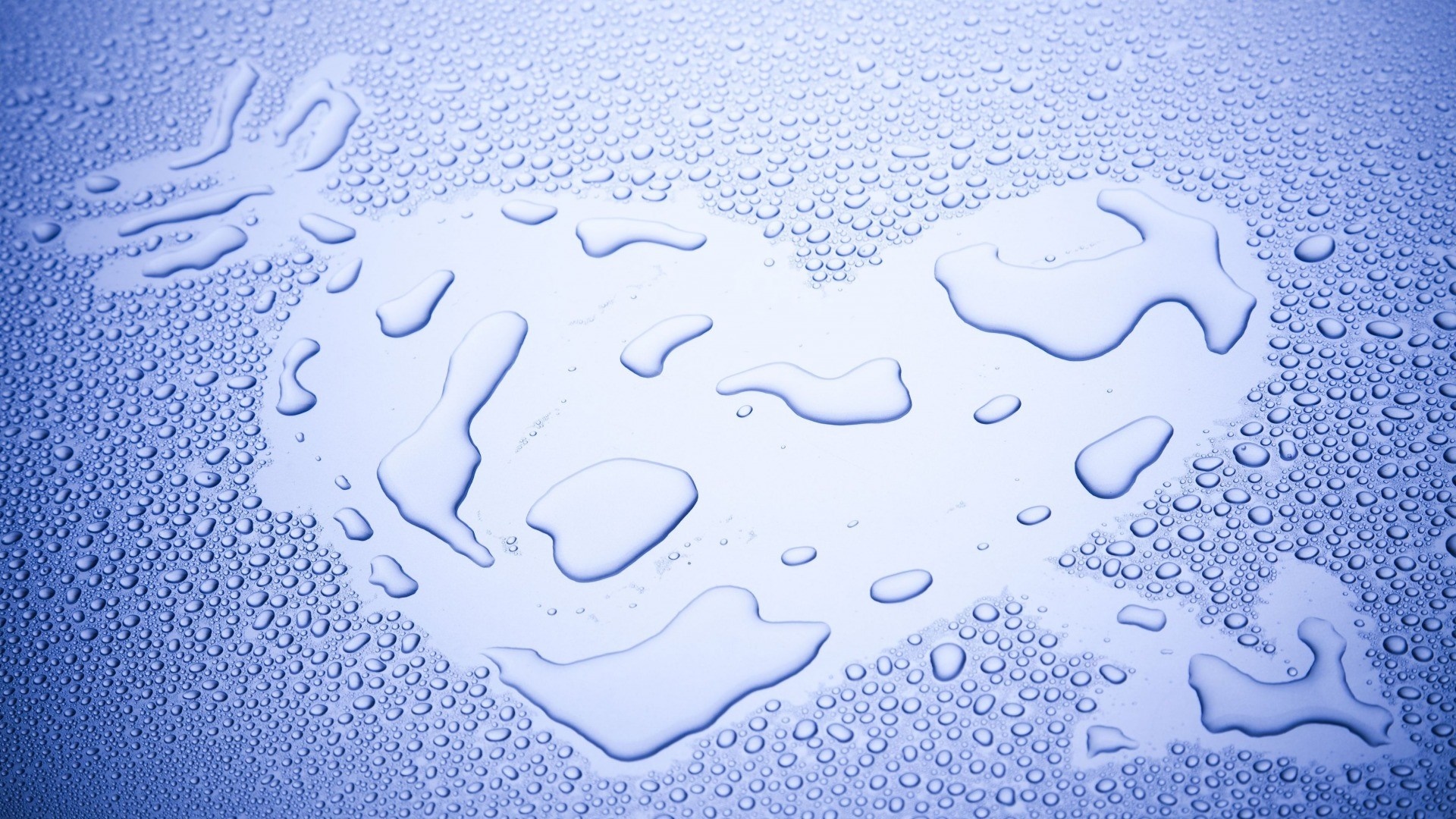 Water drops forming a heart shape on a blue surface HD Wallpaper