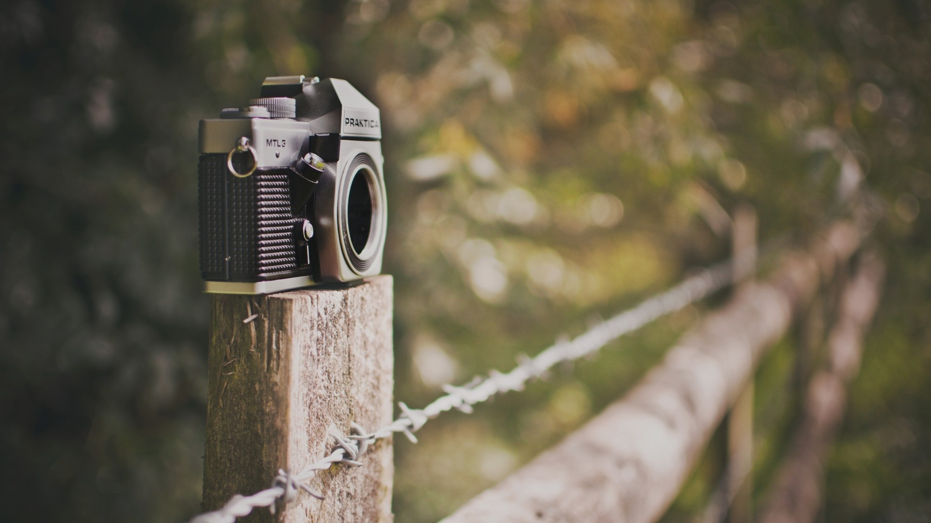Practica MTL3 camera on a wooden post with barbed wire HD Wallpaper