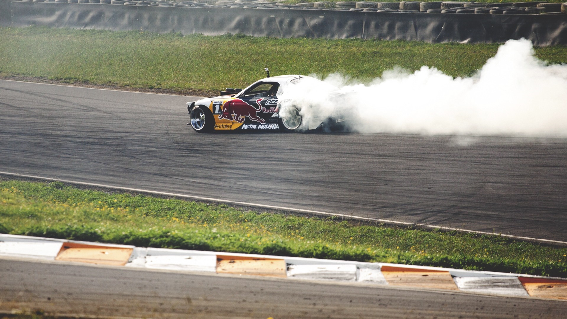 Mad Mike's Red Bull drift car on a race track HD Wallpaper