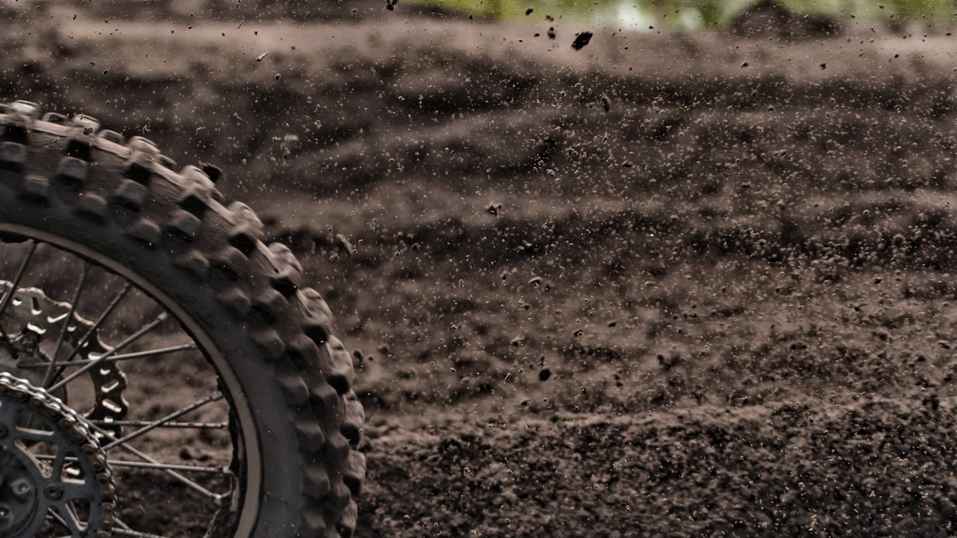 Motocross tire kicking up dirt HD Wallpaper