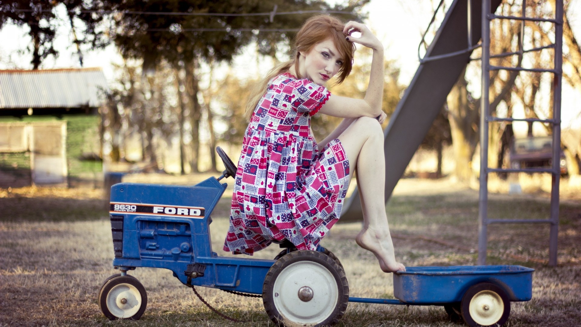 Woman on a Ford toy tractor with a wagon HD Wallpaper