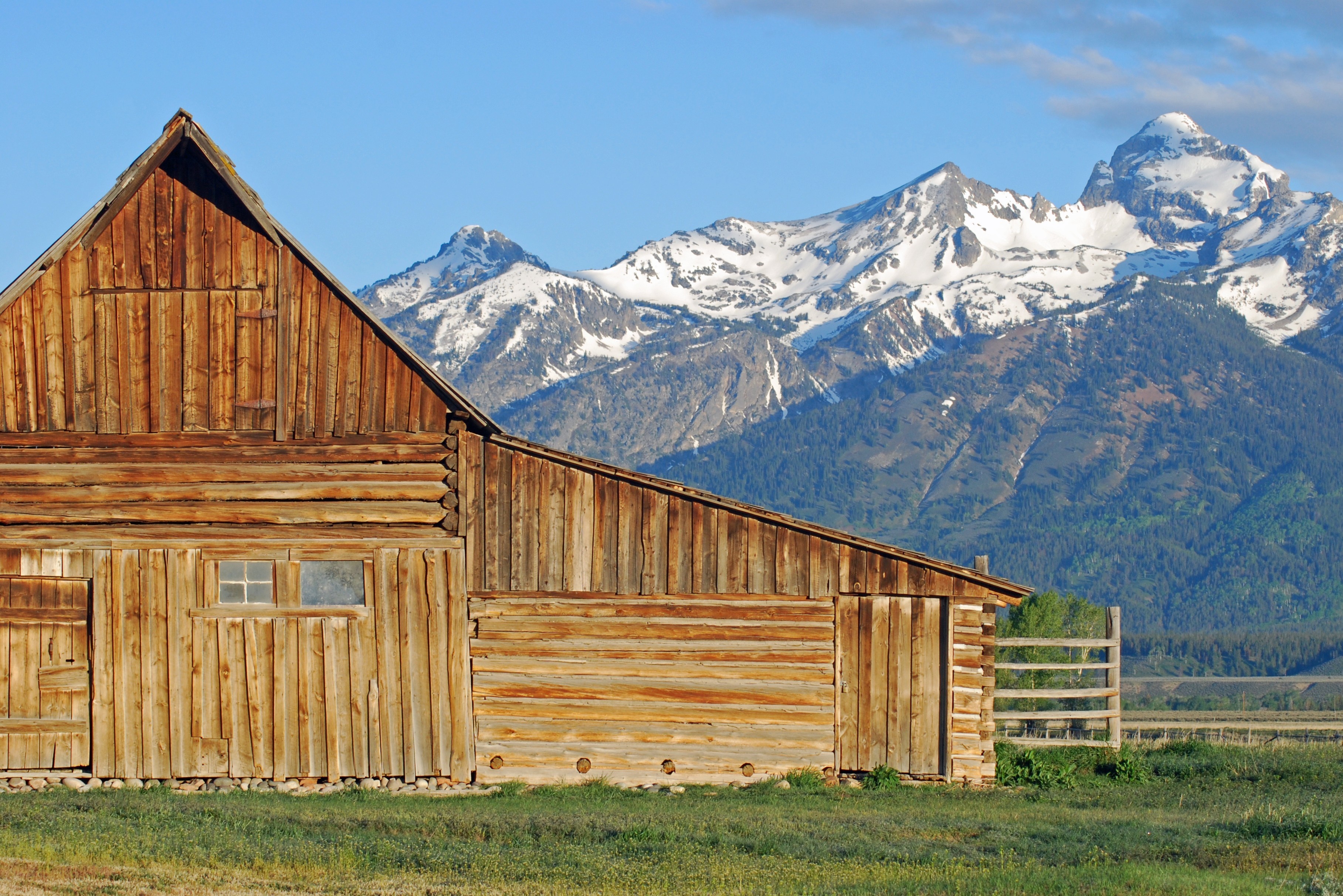 Log cabin with snow-capped mountains in the background HD Wallpaper
