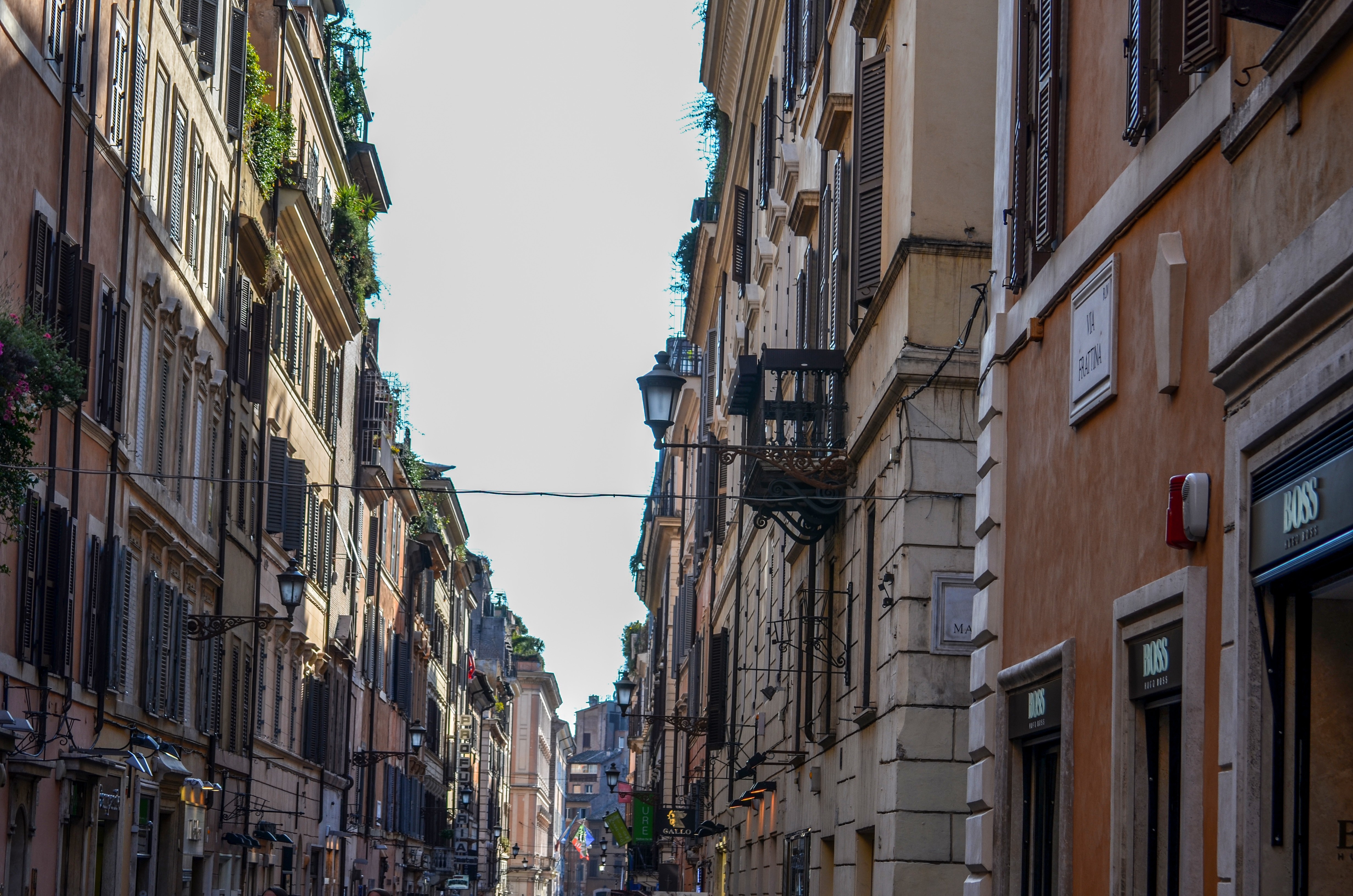 Street view of buildings with balconies and shops in Rome HD Wallpaper