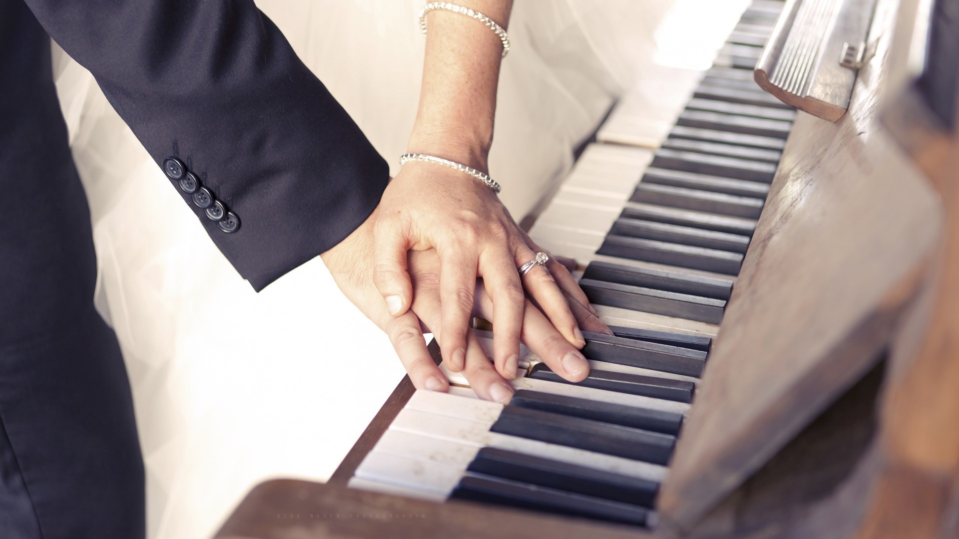 Couple's hands on a piano HD Wallpaper
