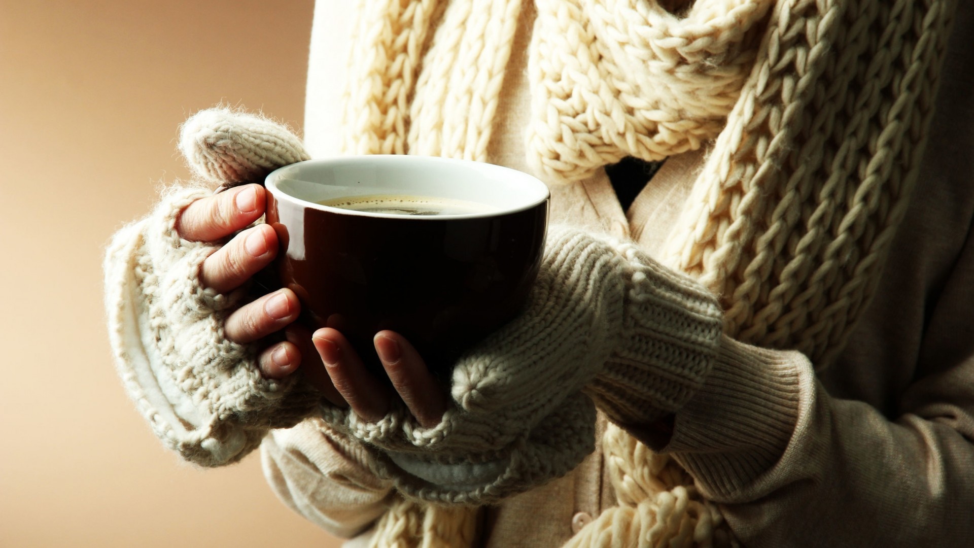 Person holding a cup of coffee in winter clothes HD Wallpaper