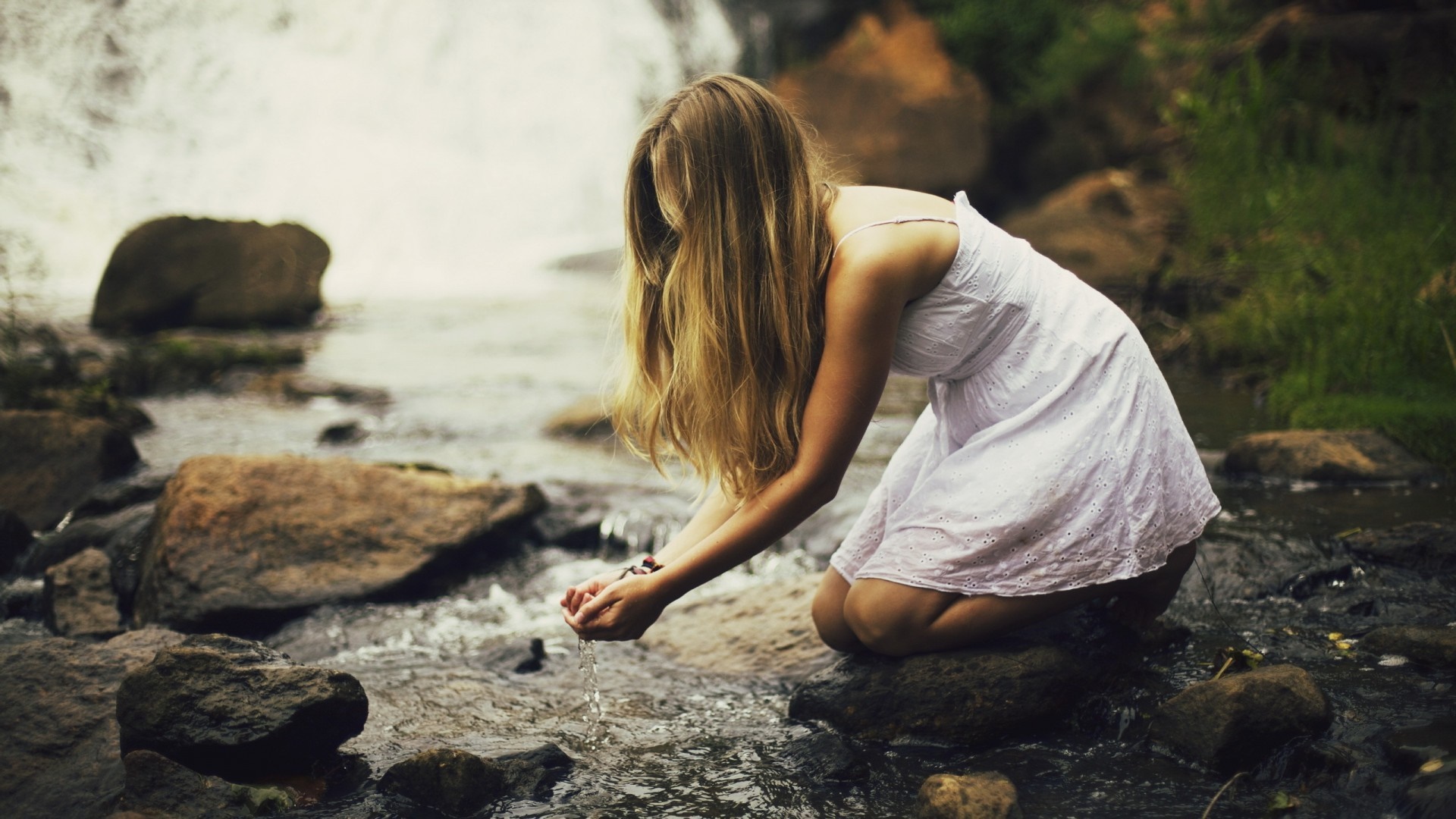 Woman in white dress by a waterfall HD Wallpaper