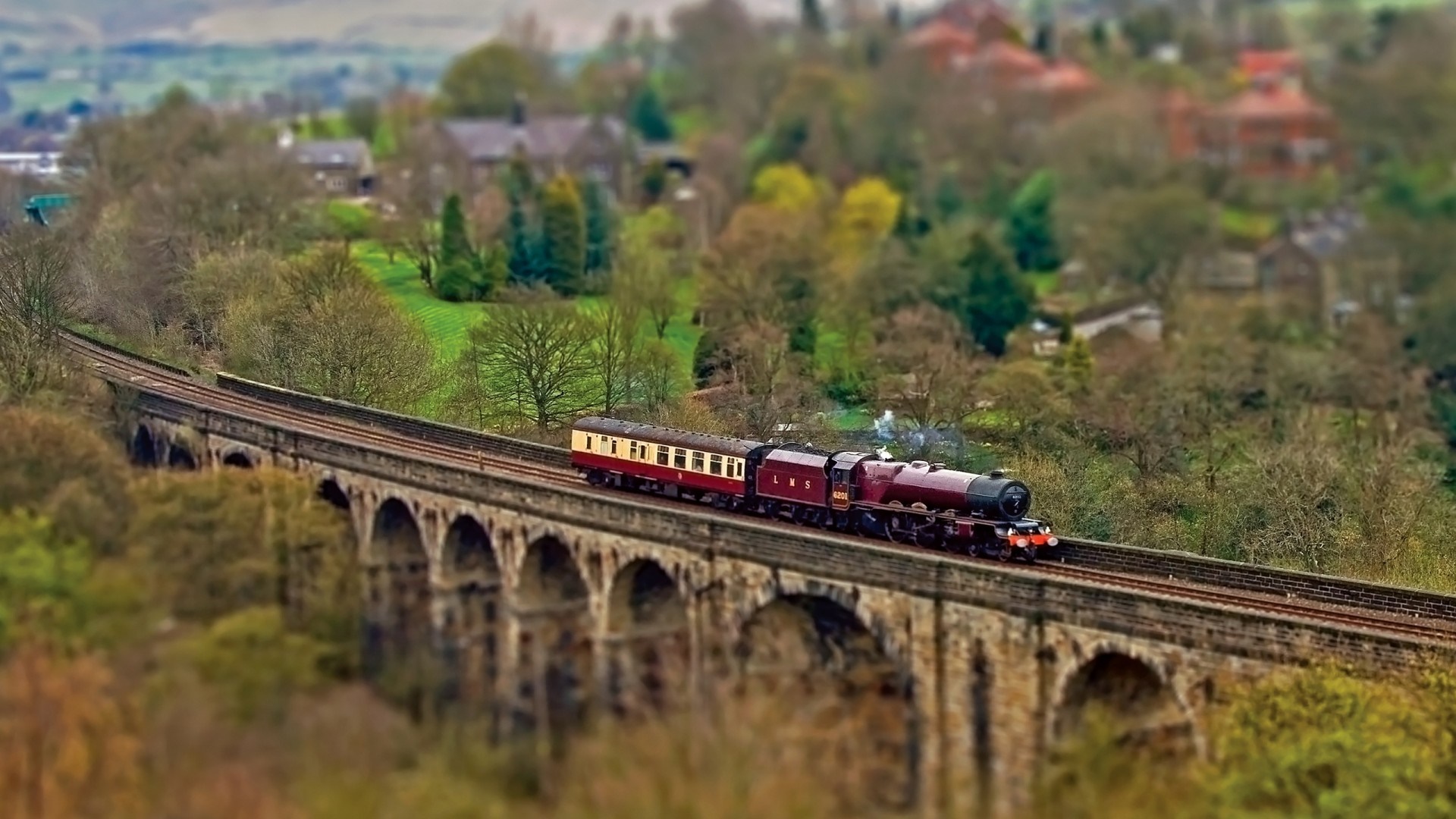 Steam train crossing a stone viaduct HD Wallpaper