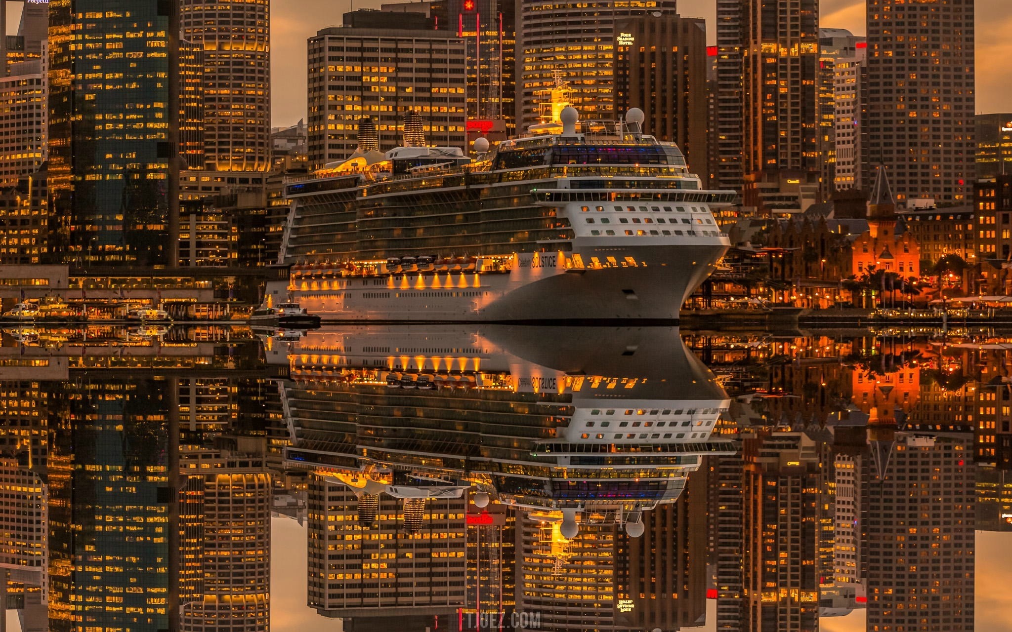 Cruise ship docked in Sydney harbor at dusk with city skyline reflection HD Wallpaper