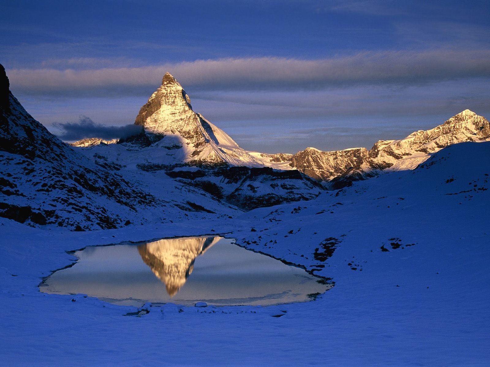 Matterhorn mountain reflected in a lake during winter HD Wallpaper