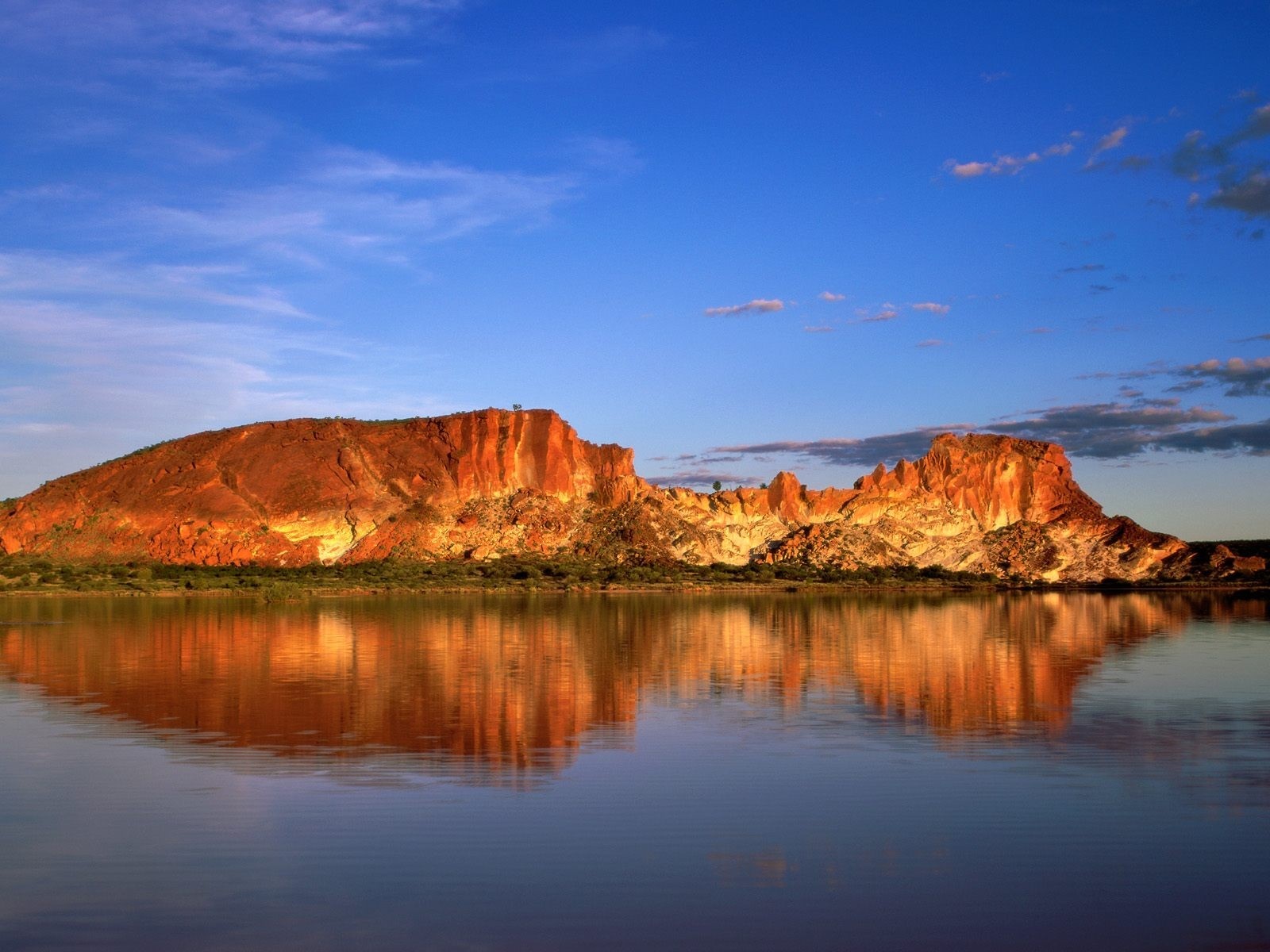 Red rock formations reflecting in a calm lake at sunset HD Wallpaper