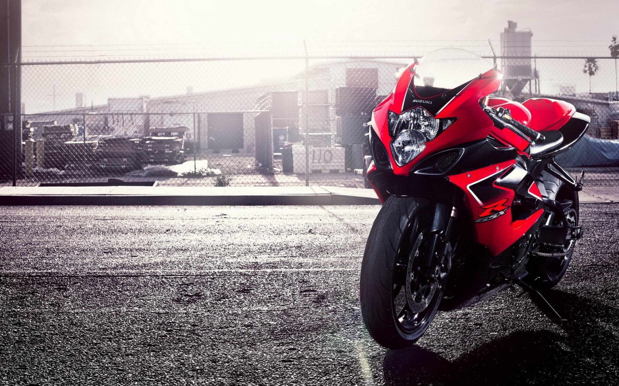 Red Suzuki GSX-R motorcycle parked on asphalt HD Wallpaper