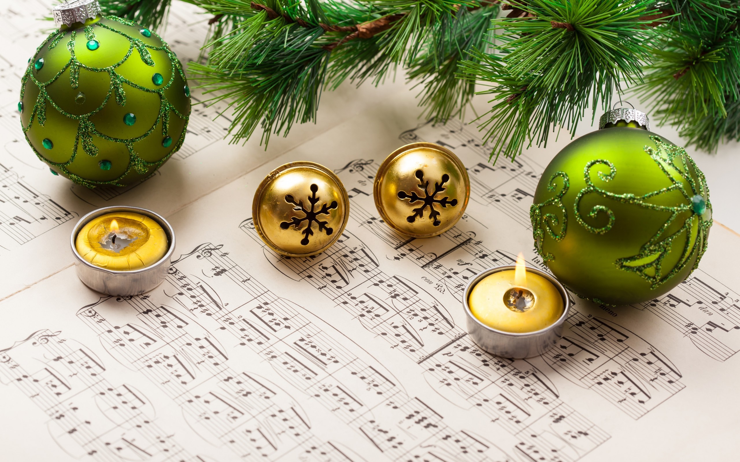 Christmas ornaments and candles on sheet music HD Wallpaper