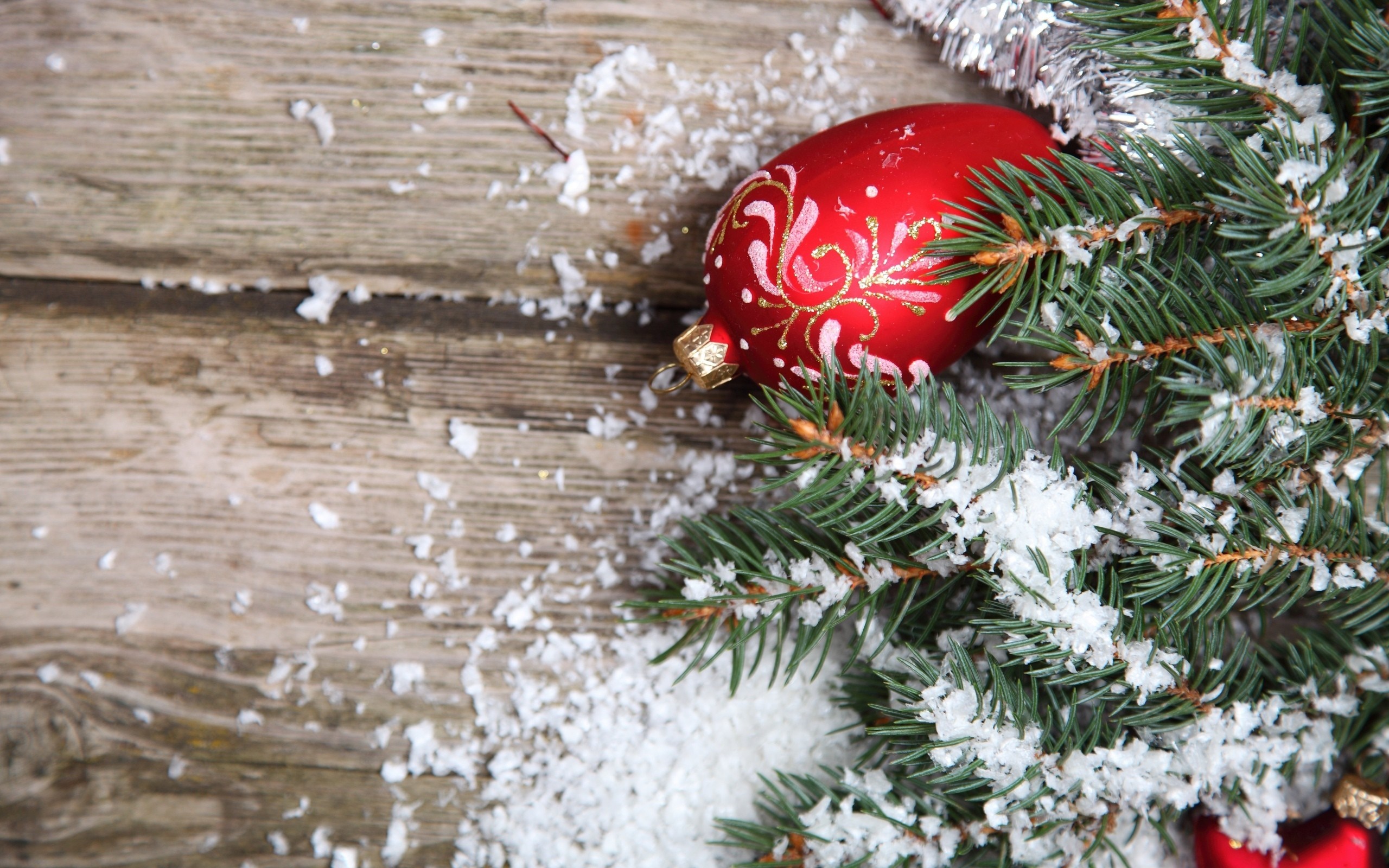 Christmas ornament on a snowy fir branch on wood HD Wallpaper